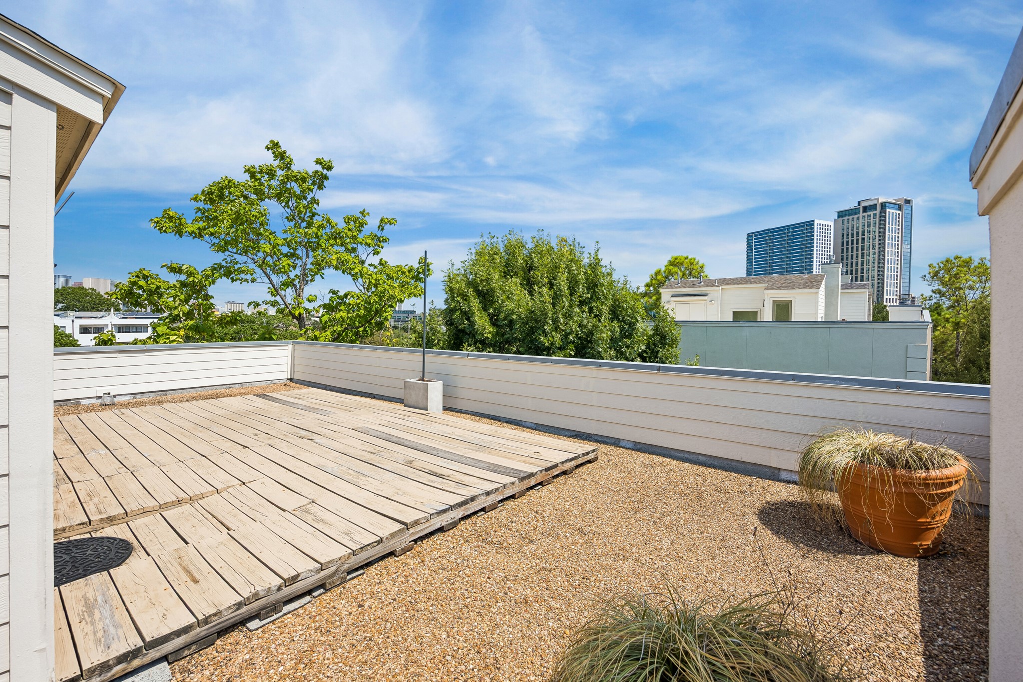 Expansive rooftop terrace offering an exceptional outdoor setting with sweeping city views. A storage shed is also conveniently located on the rooftop.