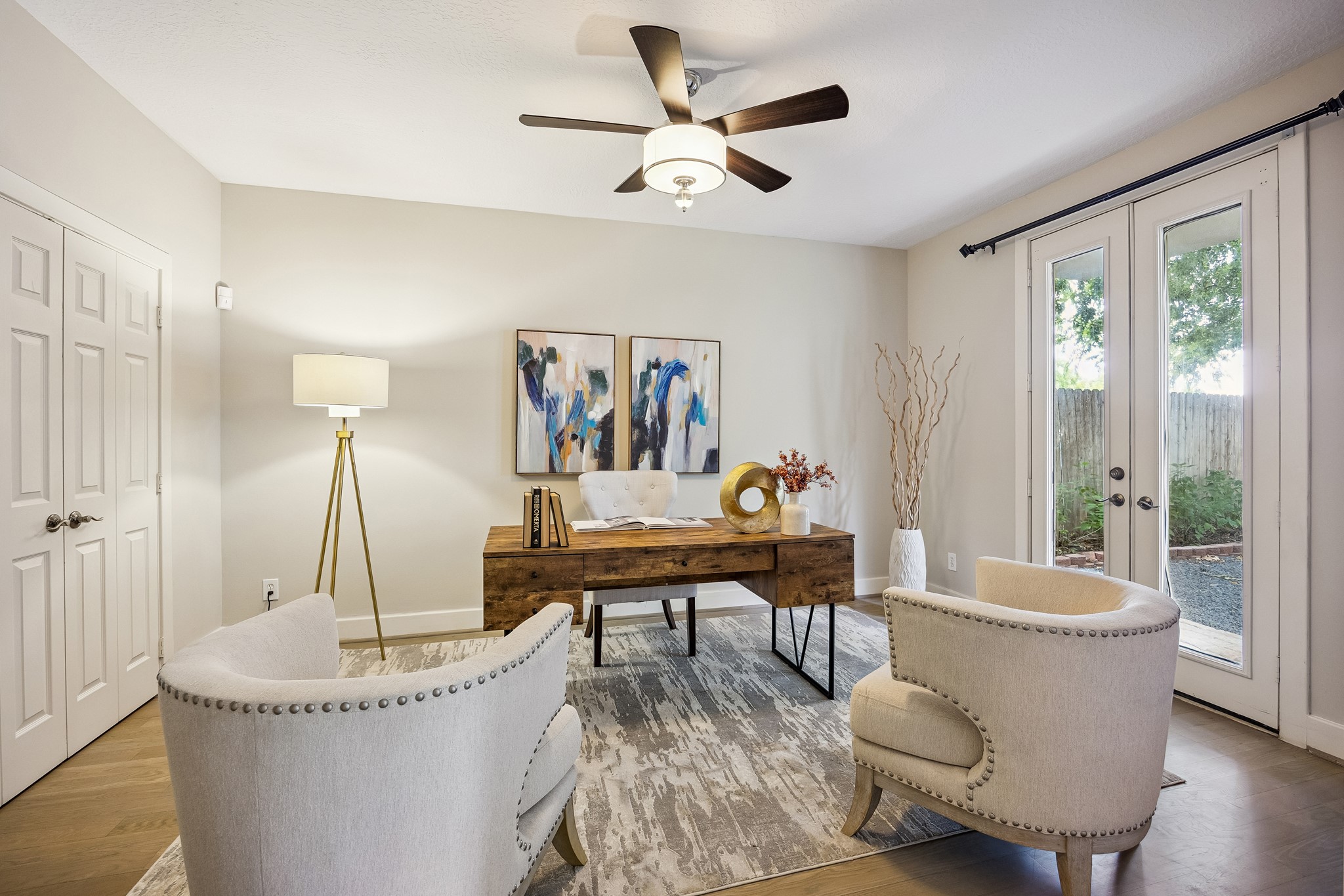 Sliding pocket doors open into the first-level bedroom with double French doors providing direct access to the yard.
