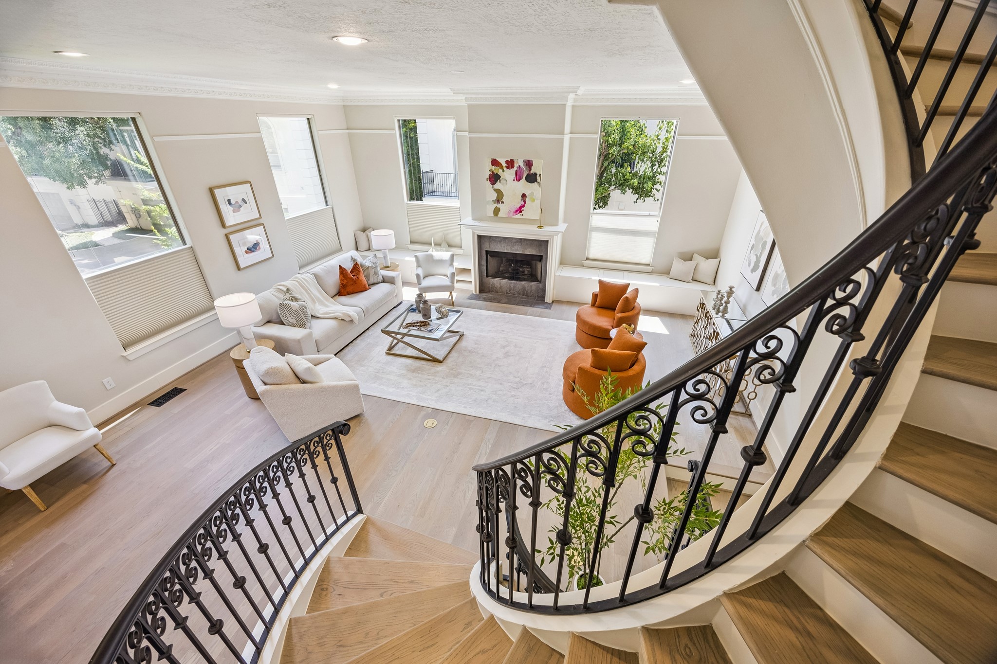 View from the staircase overlooking the spacious, light-filled living room.