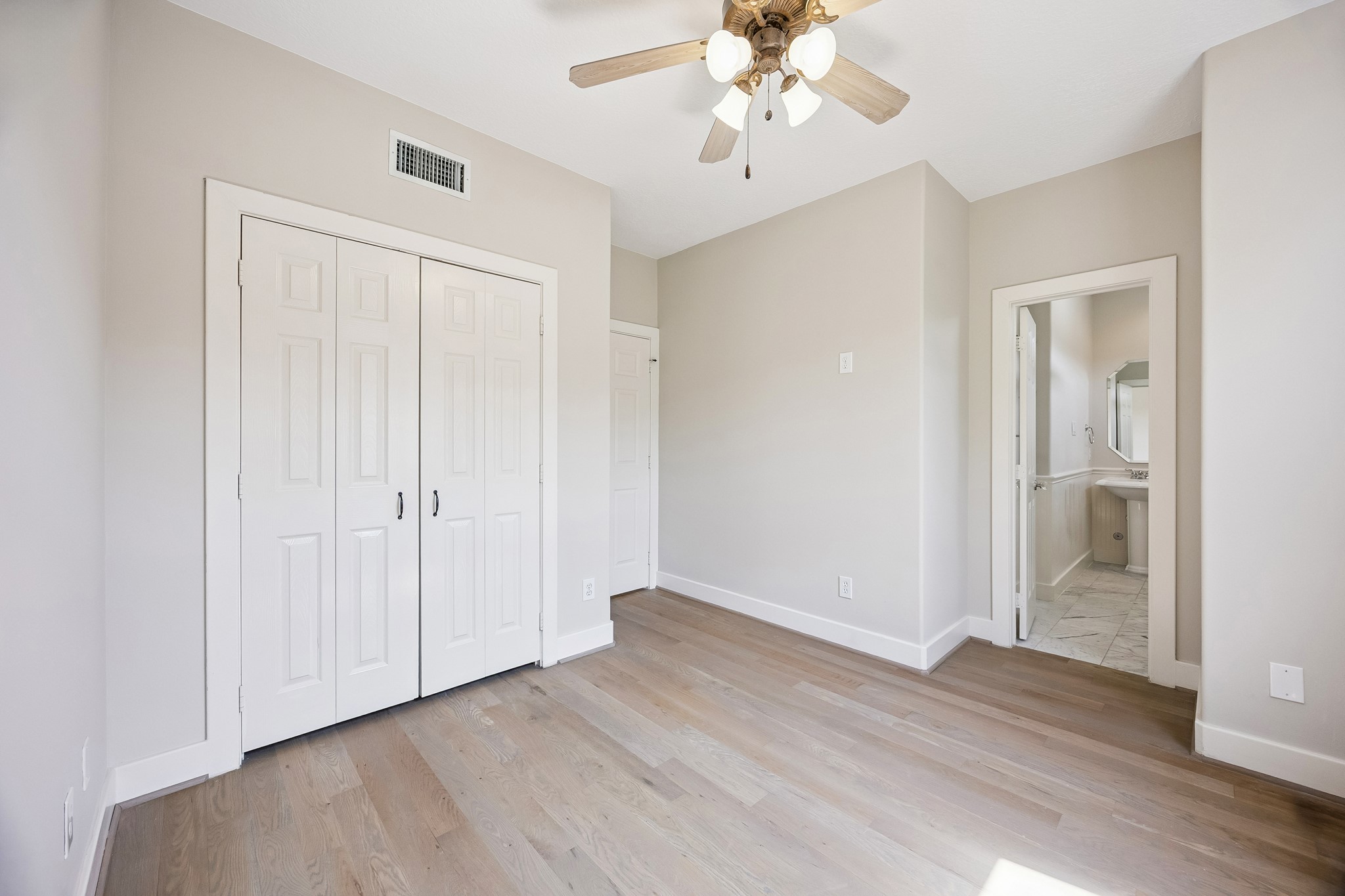 The bedroom provides a full bath and generous closet space.