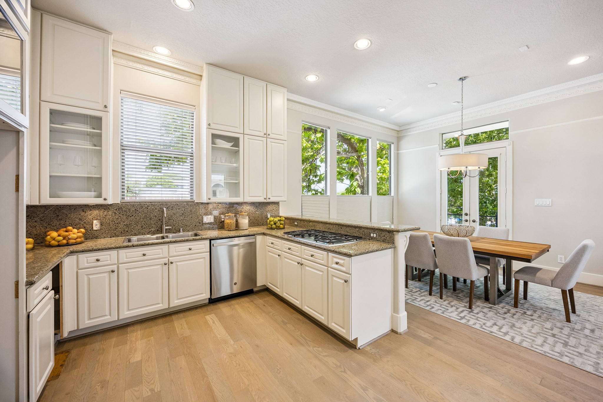 Kitchen with extensive cabinetry, under-cabinet lighting, granite counters, stainless-steel appliances and gas cooktop.