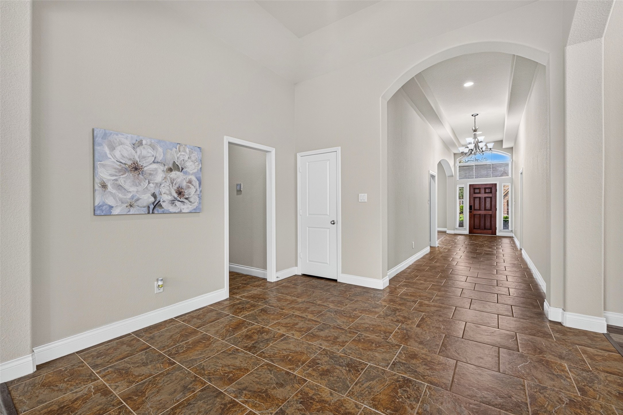 Foyer featuring soaring ceilings, beautiful tile flooring, and neutral, modern paint tones. Foyer featuring soaring ceilings, beautiful tile flooring, and neutral, modern paint tones.