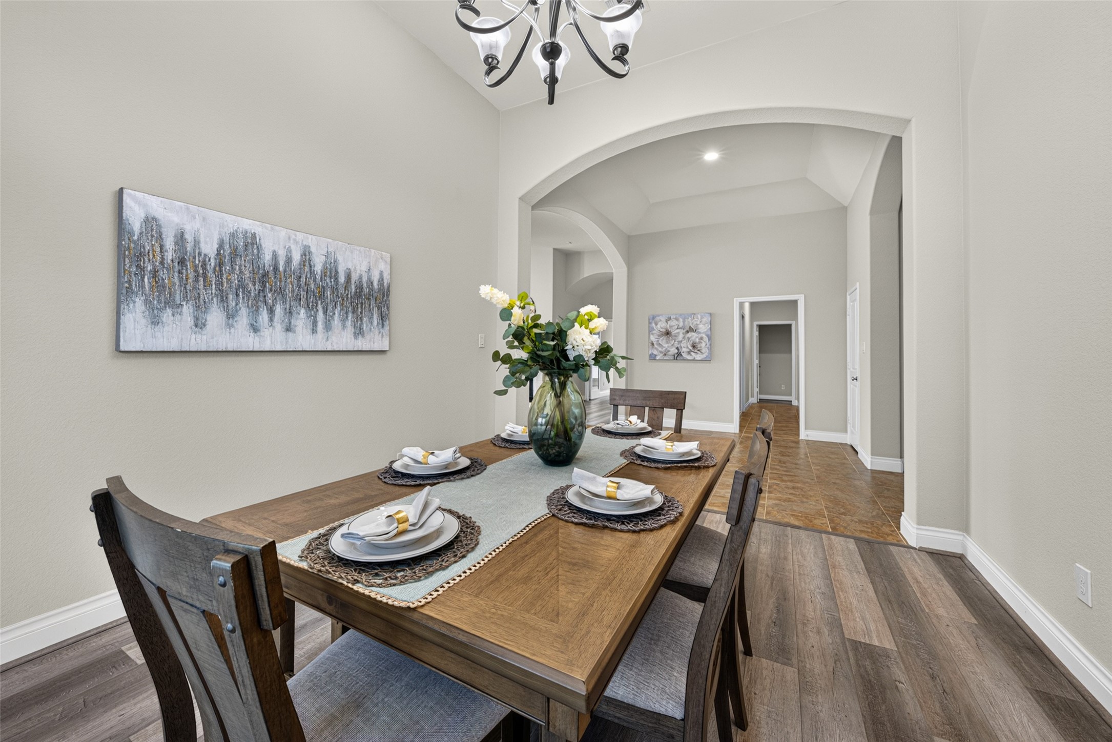 Elegant formal dining room framed by wide windows with classic plantation shutters. Elegant formal dining room framed by wide windows with classic plantation shutters.
