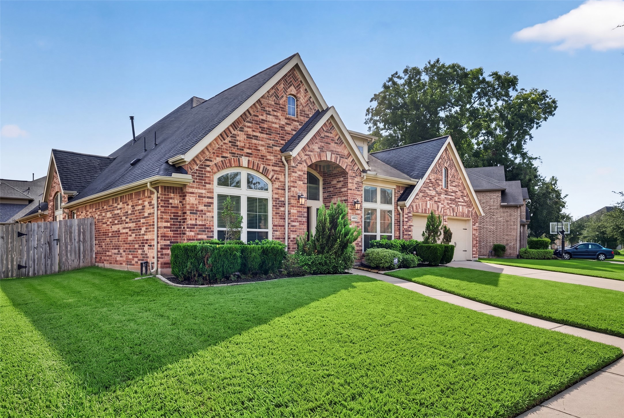 Manicured front lawn and attractive exterior showcasing meticulous care and beautiful architectural detail. Manicured front lawn and attractive exterior showcasing meticulous care and beautiful architectural detail.