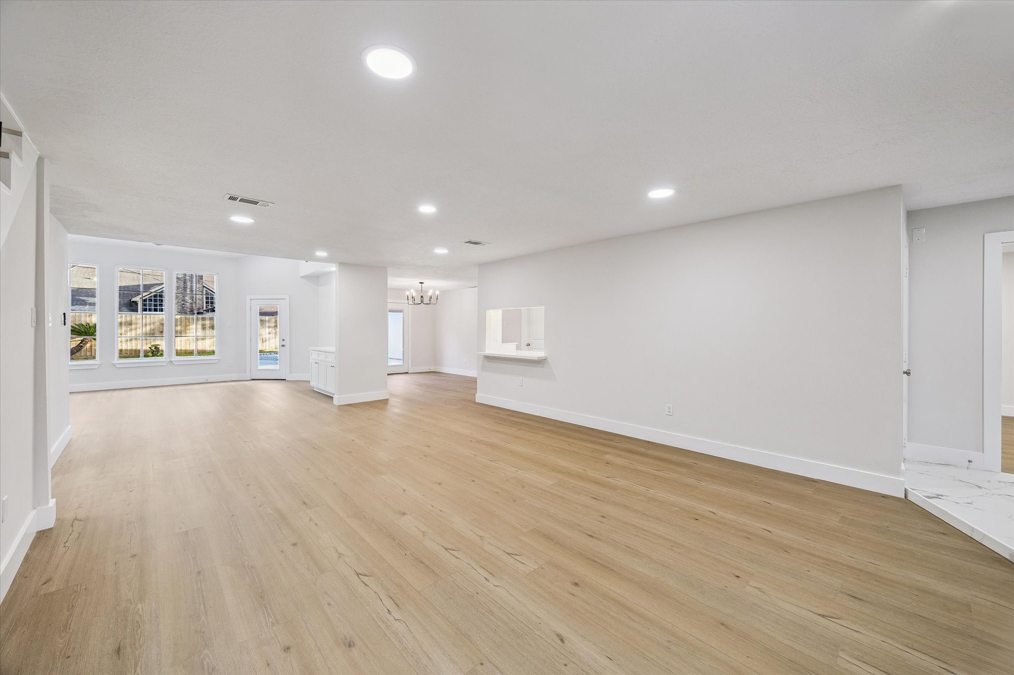 large open space, formal dining, sun room, fully renovated home throughout. light LVT flooring all throughout the first floor. LED lighting. raised ceilings.