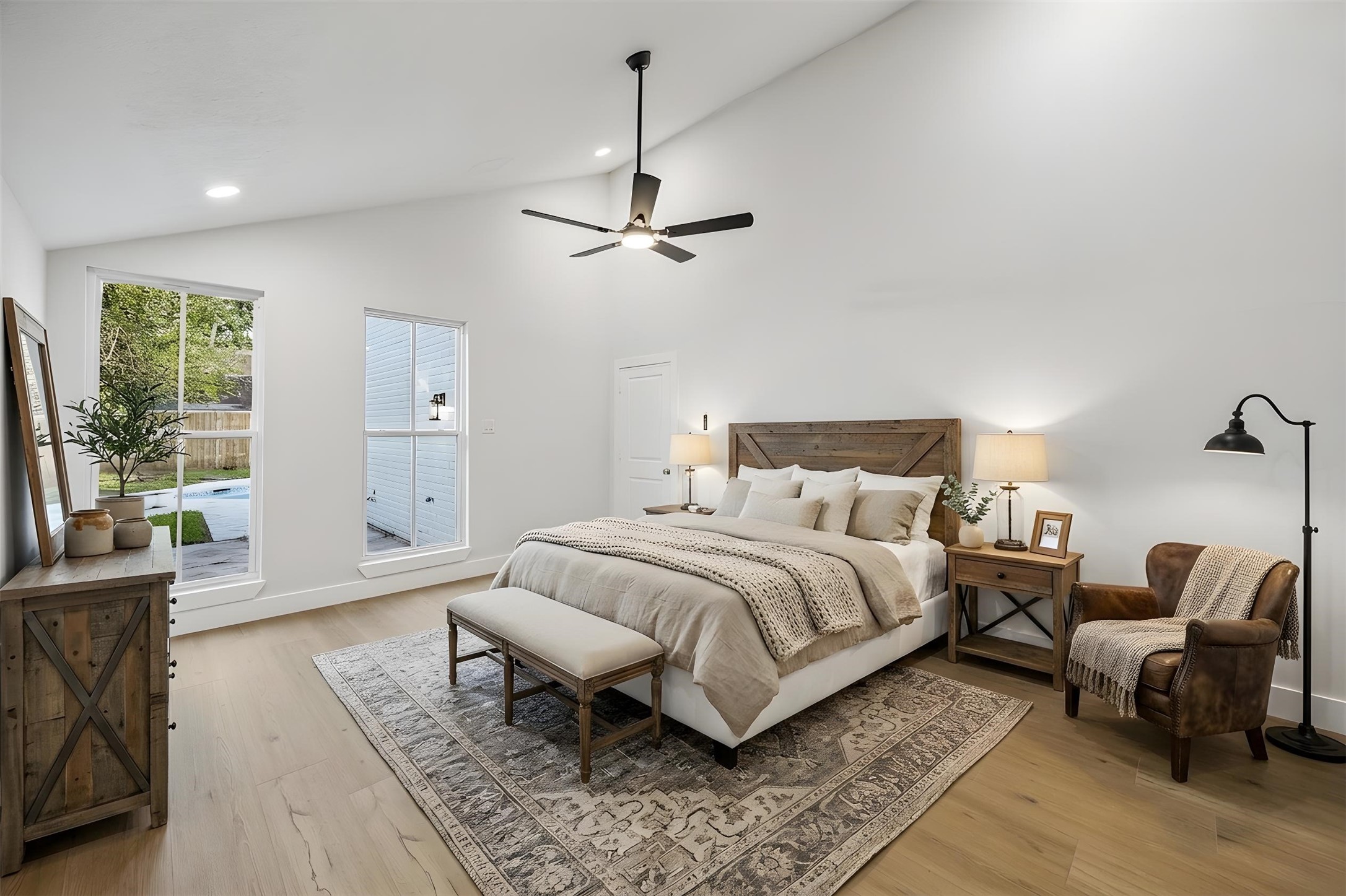 13x16 first floor primary bedroom. no carpet here. tall windows that overlook backyard. high ceilings.