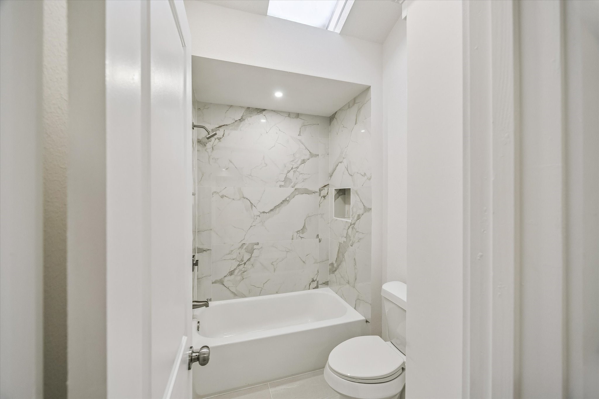 bathroom finish of shared bathroom between bedroom 2 and 3. sky-light.