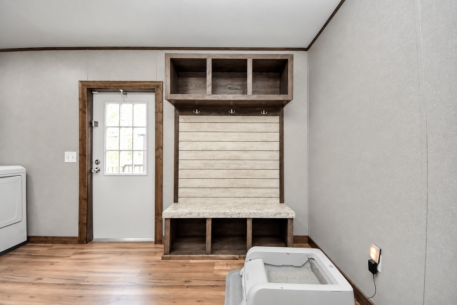 Laundry and mudroom area featuring built-in storage cubbies and direct outdoor access.
