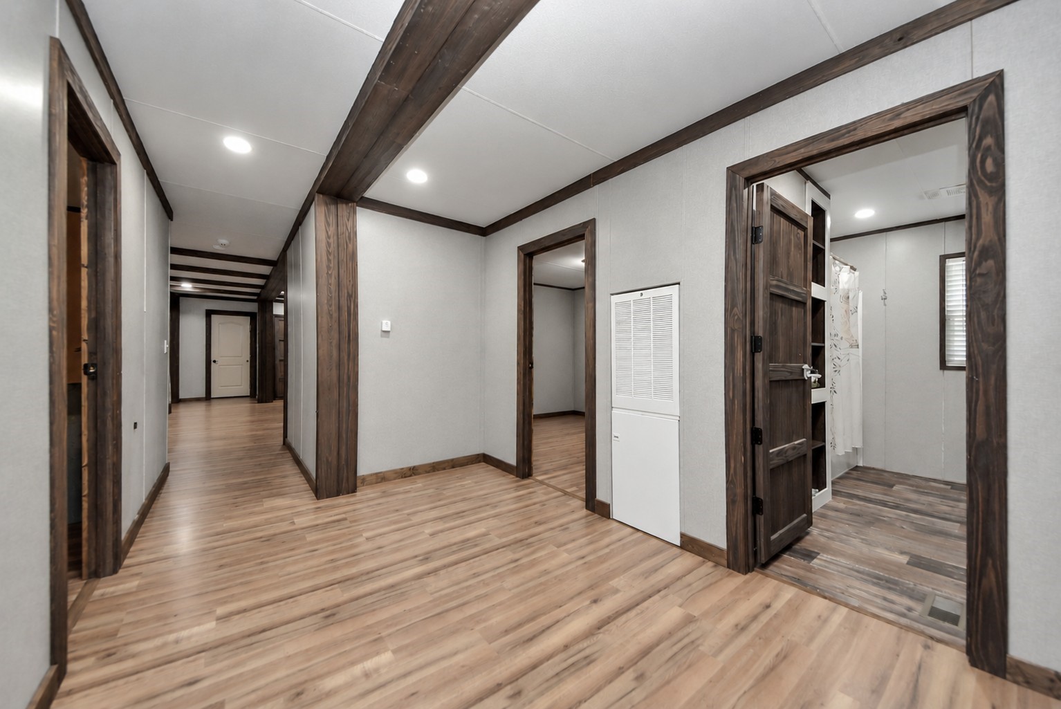 Spacious hallway connecting the secondary bedrooms.