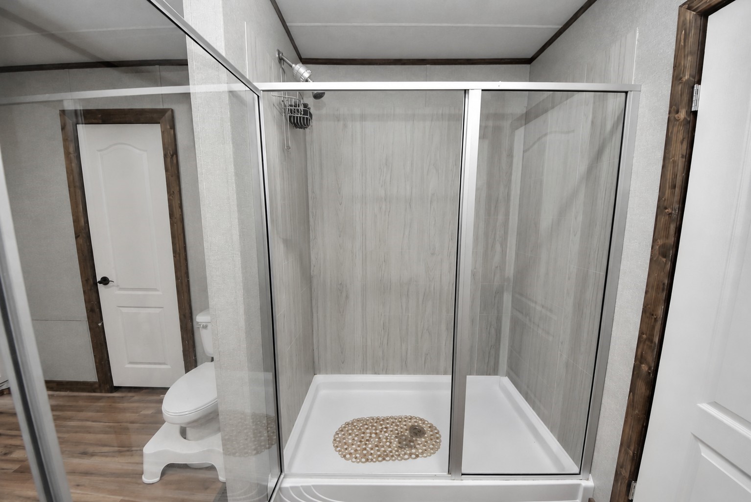 Primary bathroom with glass enclosed shower.