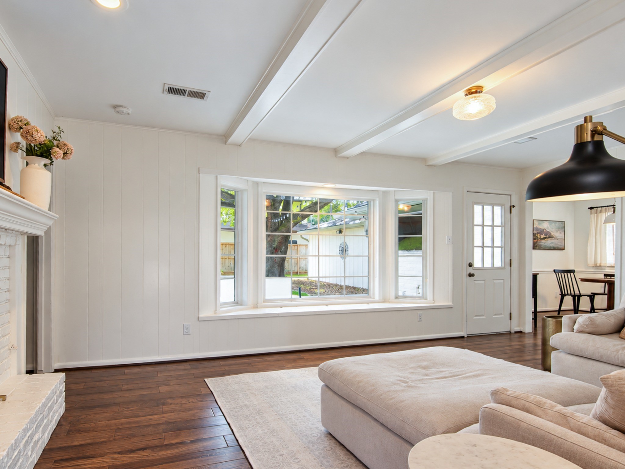 Open living space with natural lighting and a view of the backyard.