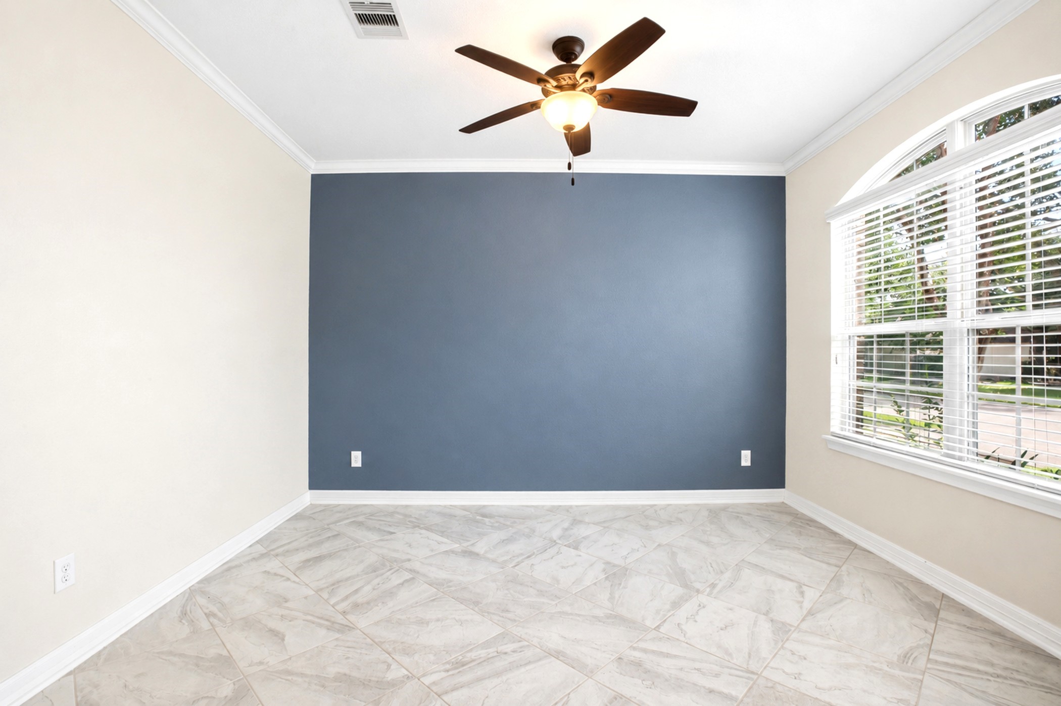 Accent wall, high ceilings, and fan complete the flex space