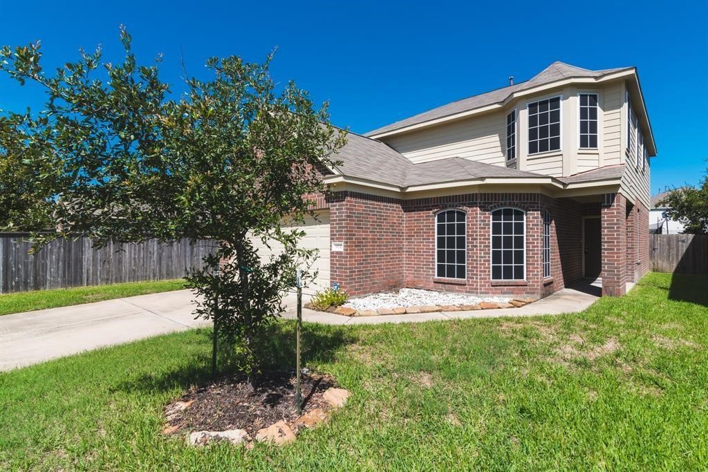 A large front yard and mature landscape