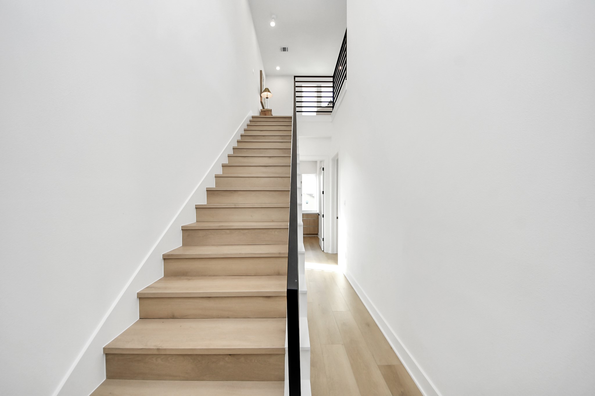 Modern staircase leading to the fourth-floor living space and rooftop terrace.