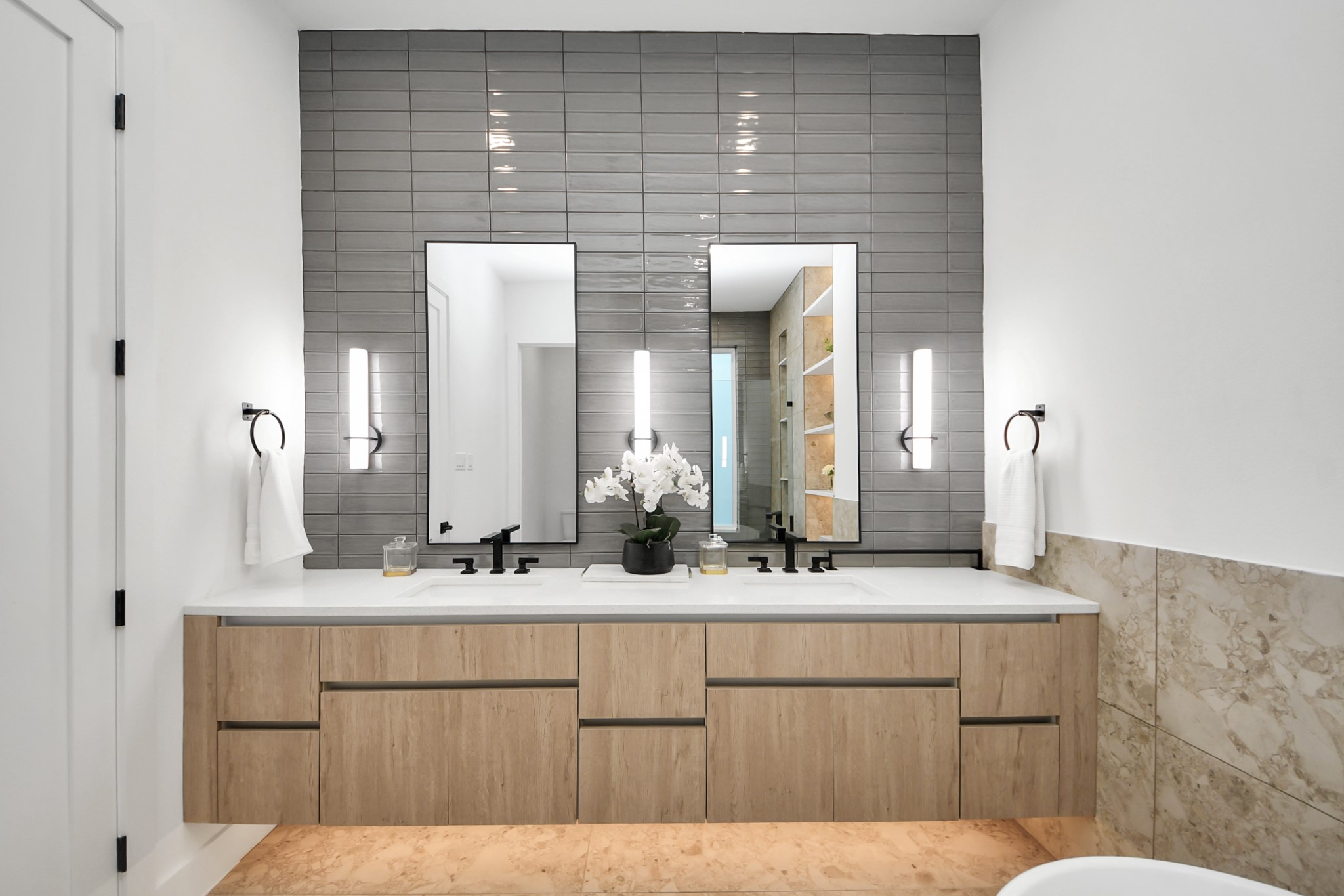 Primary bathroom with a spacious double vanity and modern black fixtures.