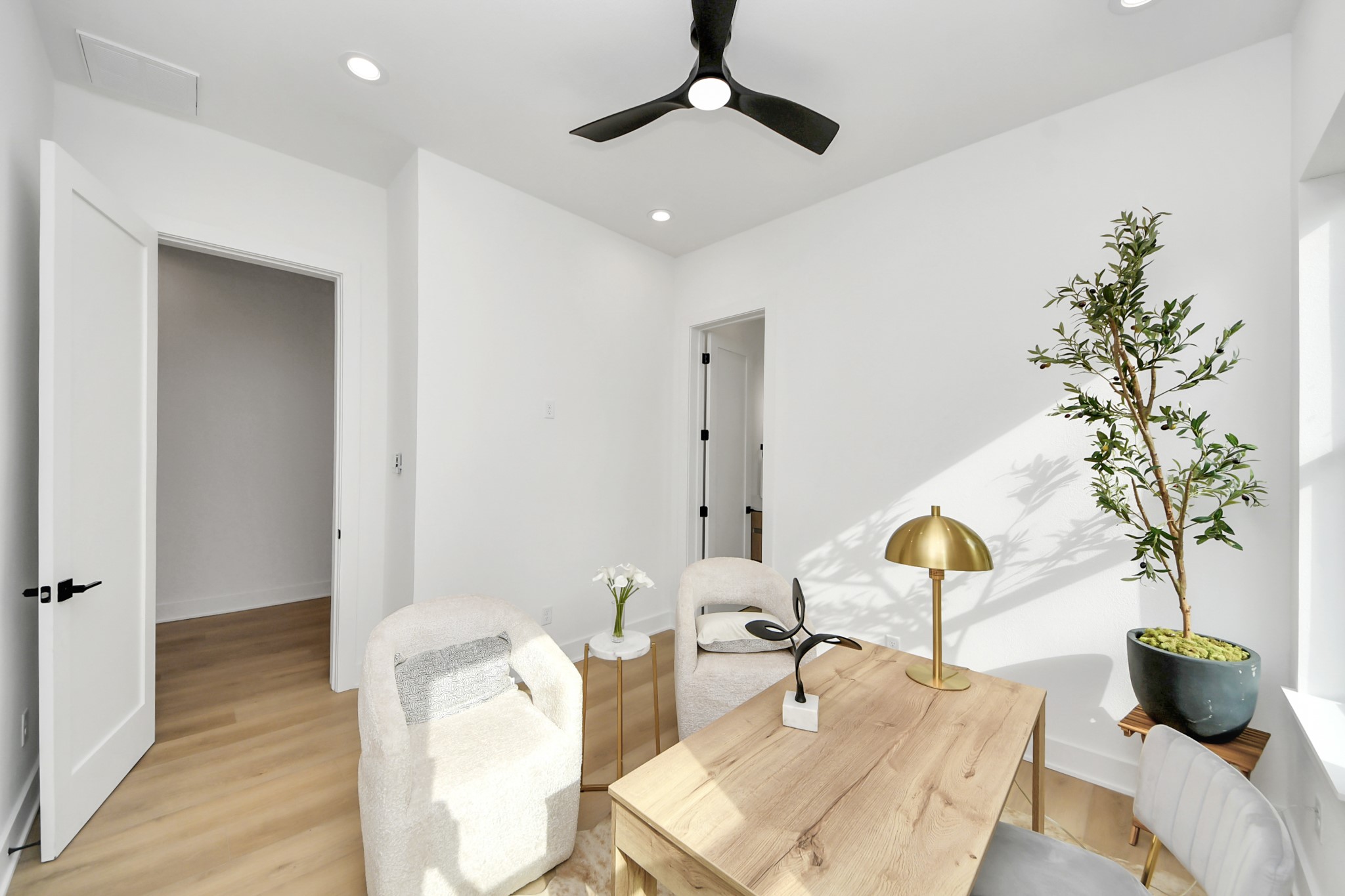 Versatile office or sitting room with modern furnishings and abundant natural light.