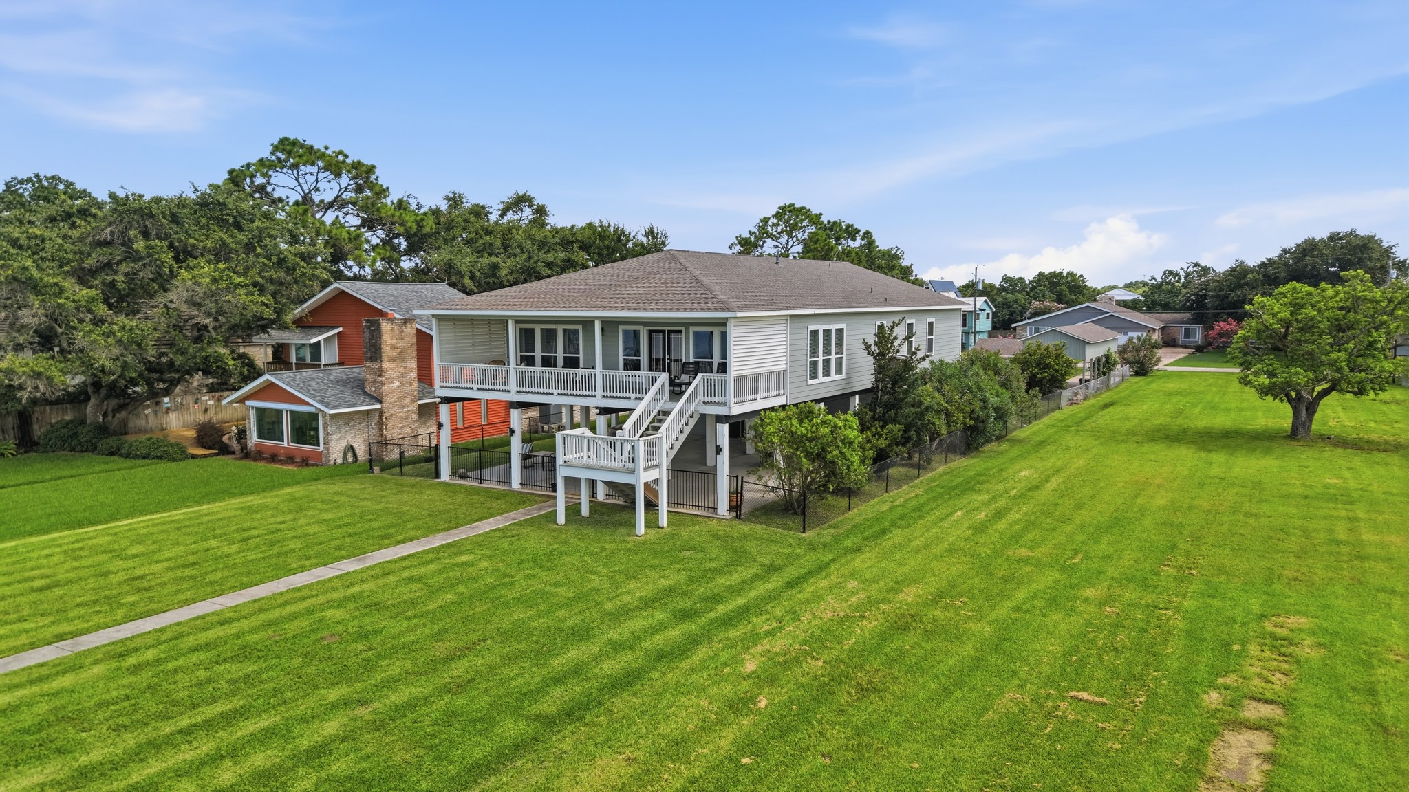 Step out onto a grand, beautifully manicured lawn that leads straight to the water's edge.