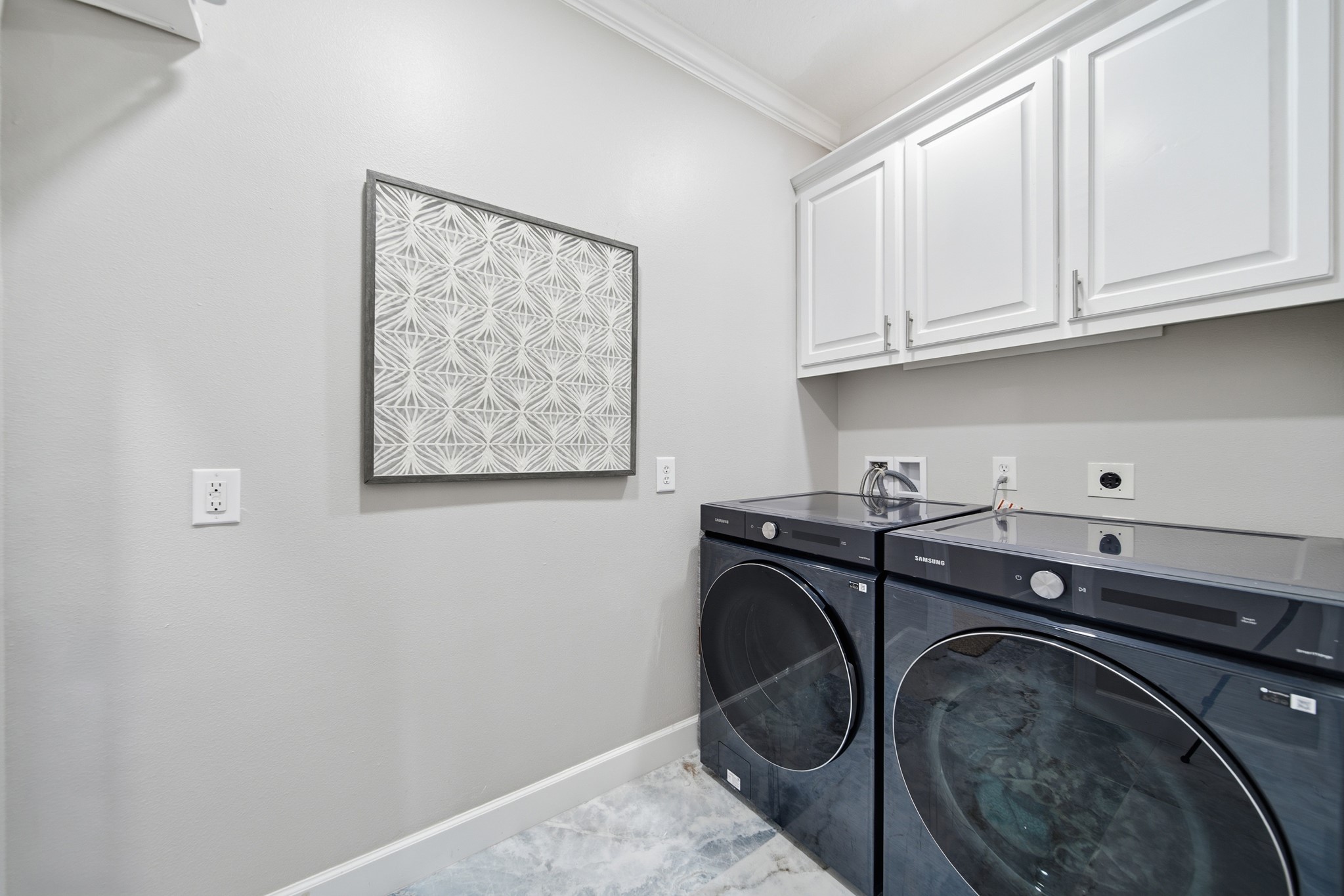 Enjoy the everyday convenience of a spacious, organized laundry room with built-in storage.
