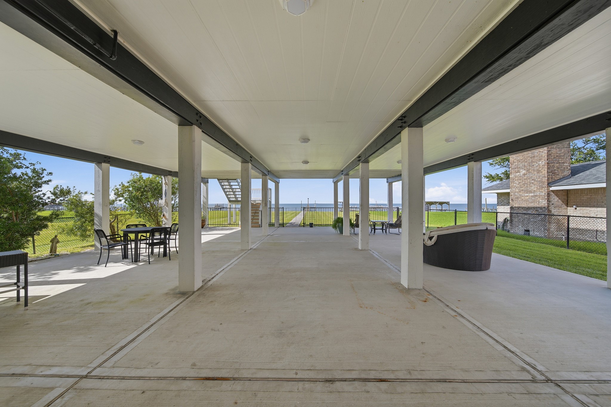 Relax on a massive ground-level patio built for ultimate coastal living.