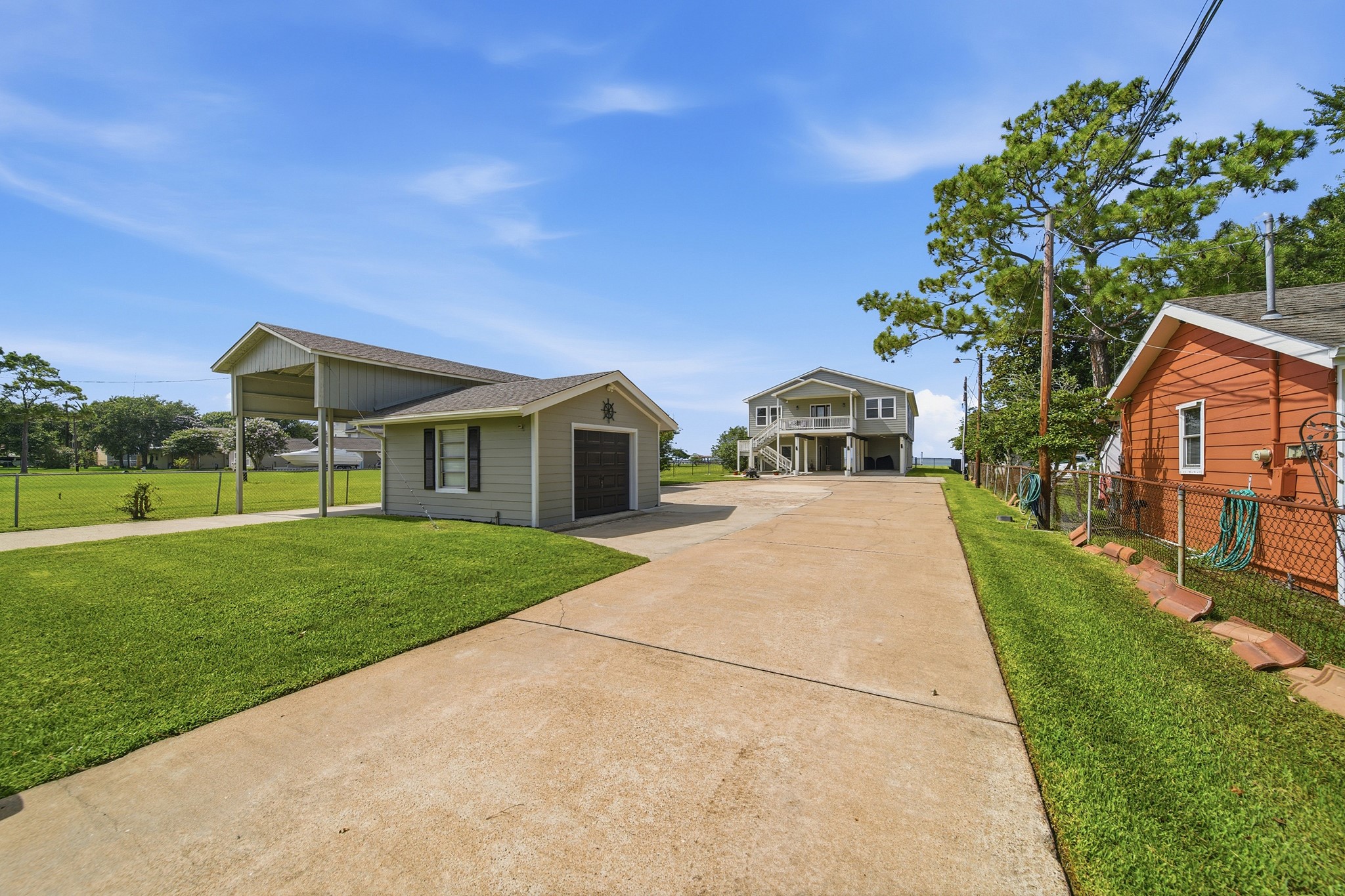 A secure, gated entrance welcomes you down a pristine, expansive driveway.