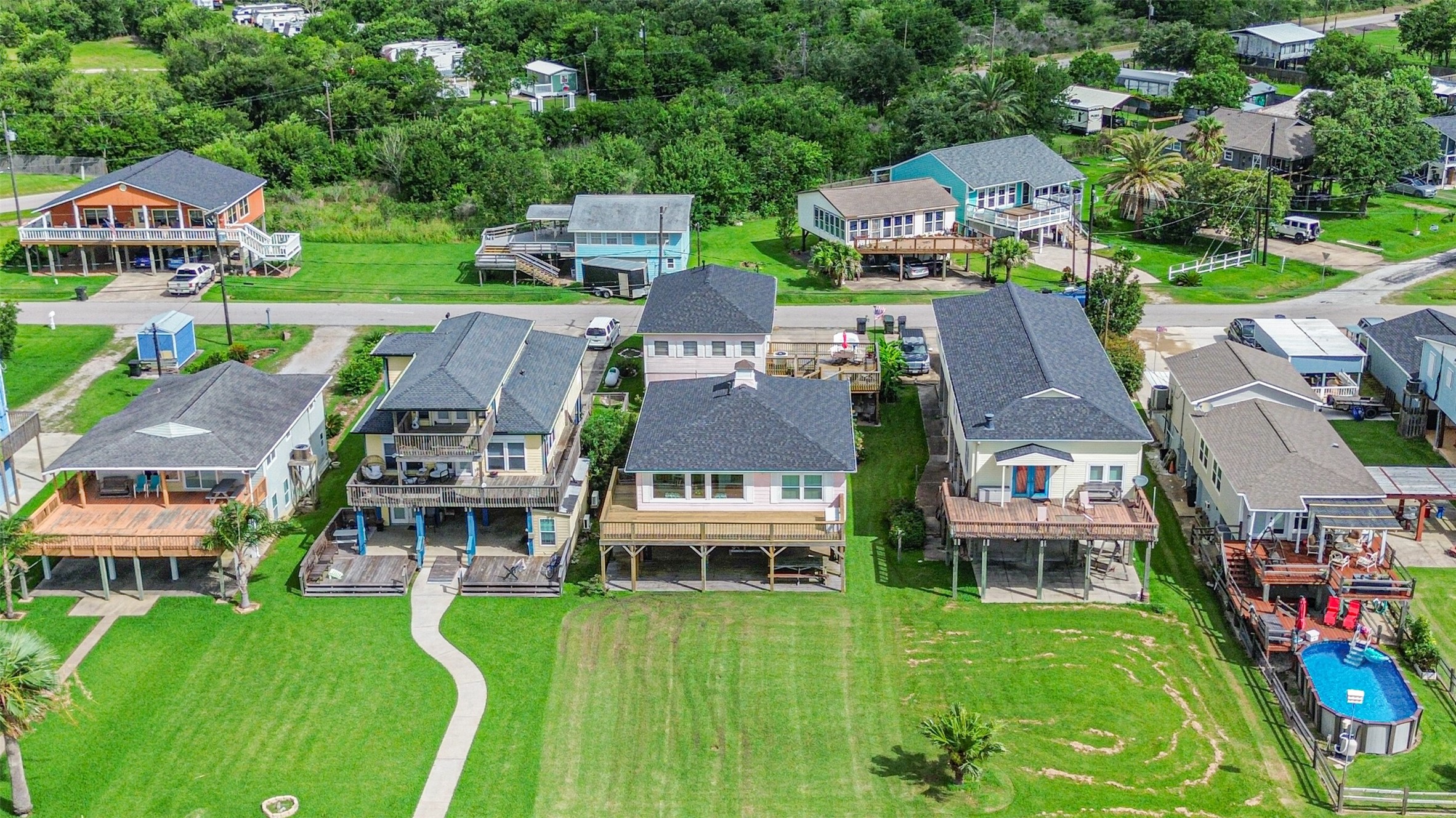 Subject property is the third home from the left in the aerial image.