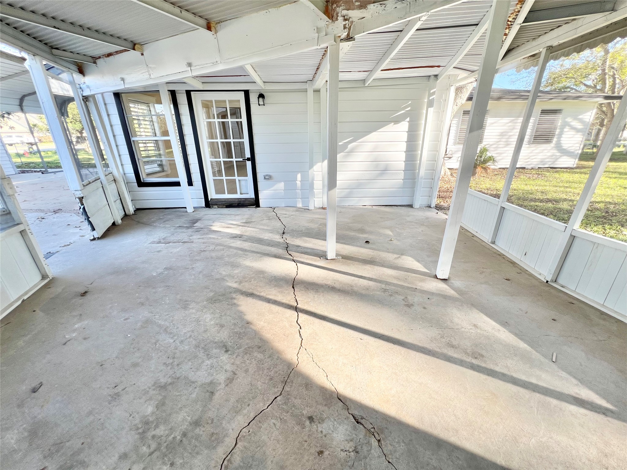 Under the screened in back patio that attaches the oversized garage and workshop to the home.