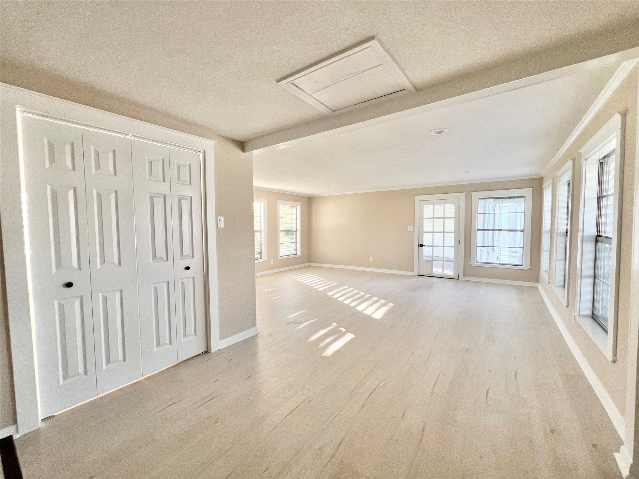 Flex room, probably the largest open space in the home and it has a little cat or dog door there that leads to the covered screened patio.  Behind the bifold doors there to the left is the utility room.