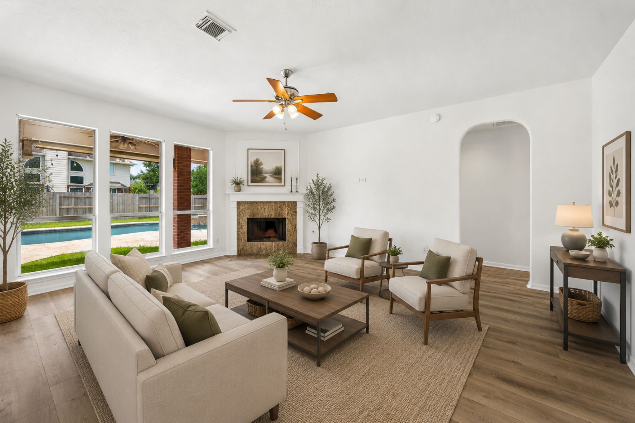 The spacious family room features a cozy fireplace and large windows overlooking the pool and backyard. **Virtually Stage.