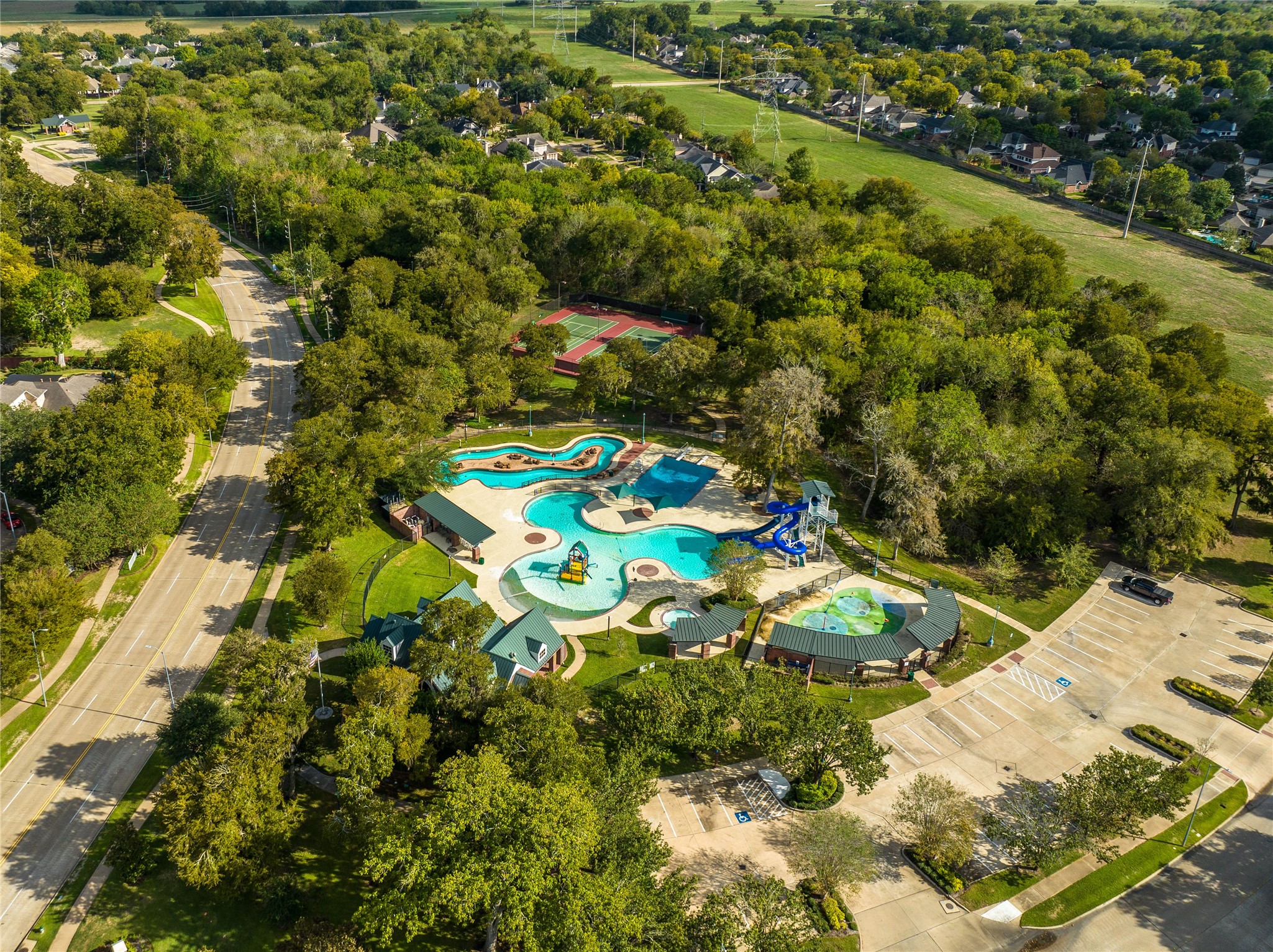FROM KIDDIE SPLASH ZONES AND TOWERING SLIDES TO SHADED LOUNGING AREAS AND SCENIC WALKING TRAILS, THIS AMENITY-RICH AQUATIC COMPLEX OFFERS FUN FOR ALL AGES.