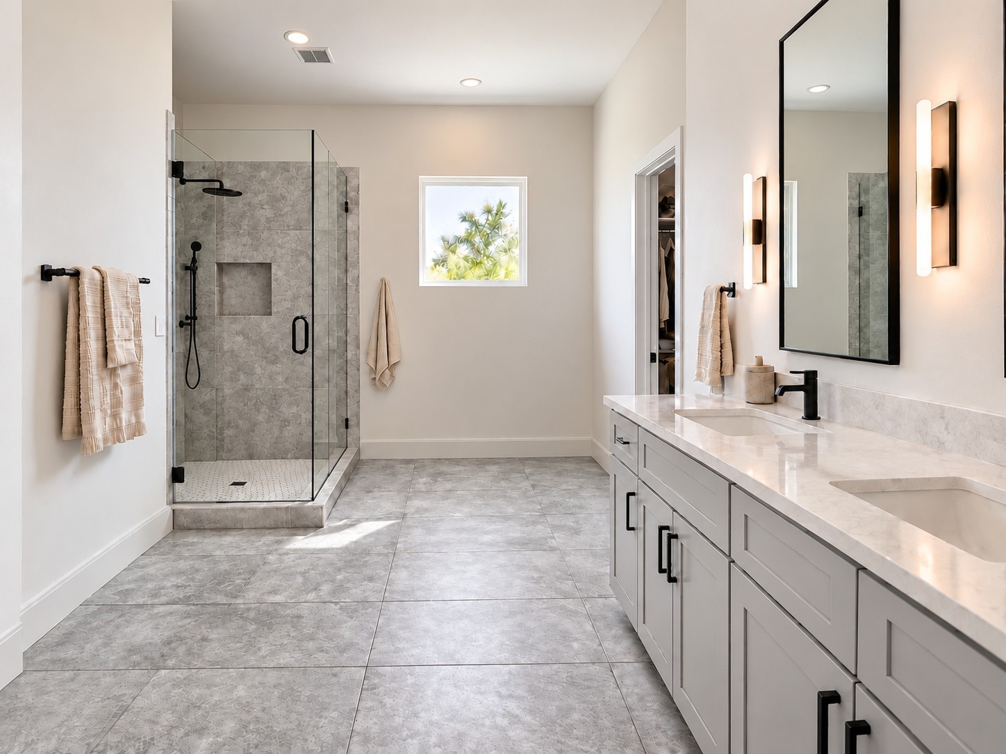 Indulge in the comfort of this spacious primary bathroom featuring sophisticated contemporary finishes and a beautifully coordinated neutral palette. A large double-sink vanity offers generous countertop space, ample cabinetry, sleek black fixtures, and elegant framed mirrors. The oversized glass-enclosed shower showcases decorative tile, a rainfall showerhead, and a built-in storage niche. These photos have been virtually rendered for visual reference.