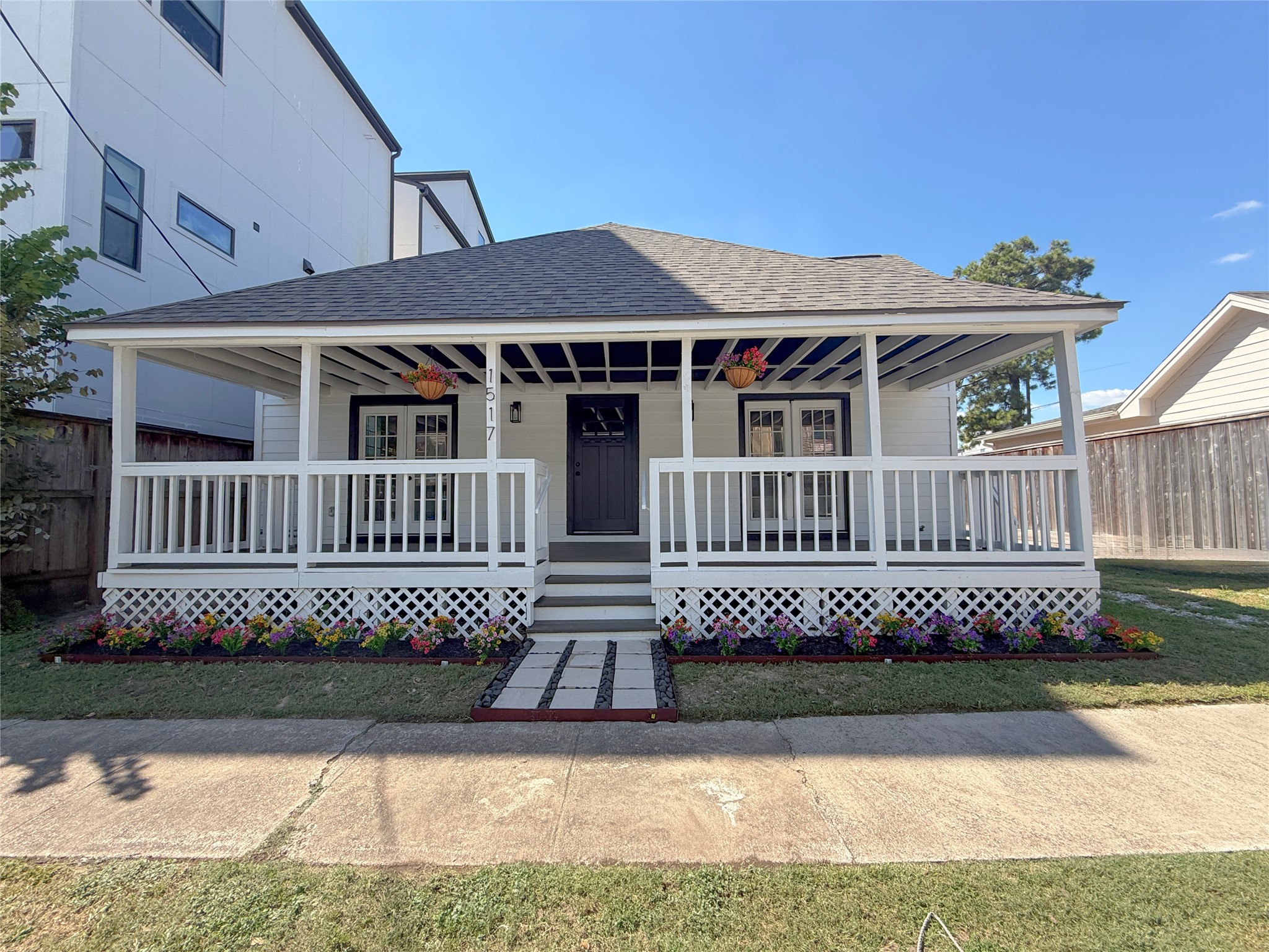 Beautifully updated home featuring a welcoming, double-wide covered front porch, fresh landscaping, and charming architectural details that enhance its curb appeal AND A NEW ROOF!