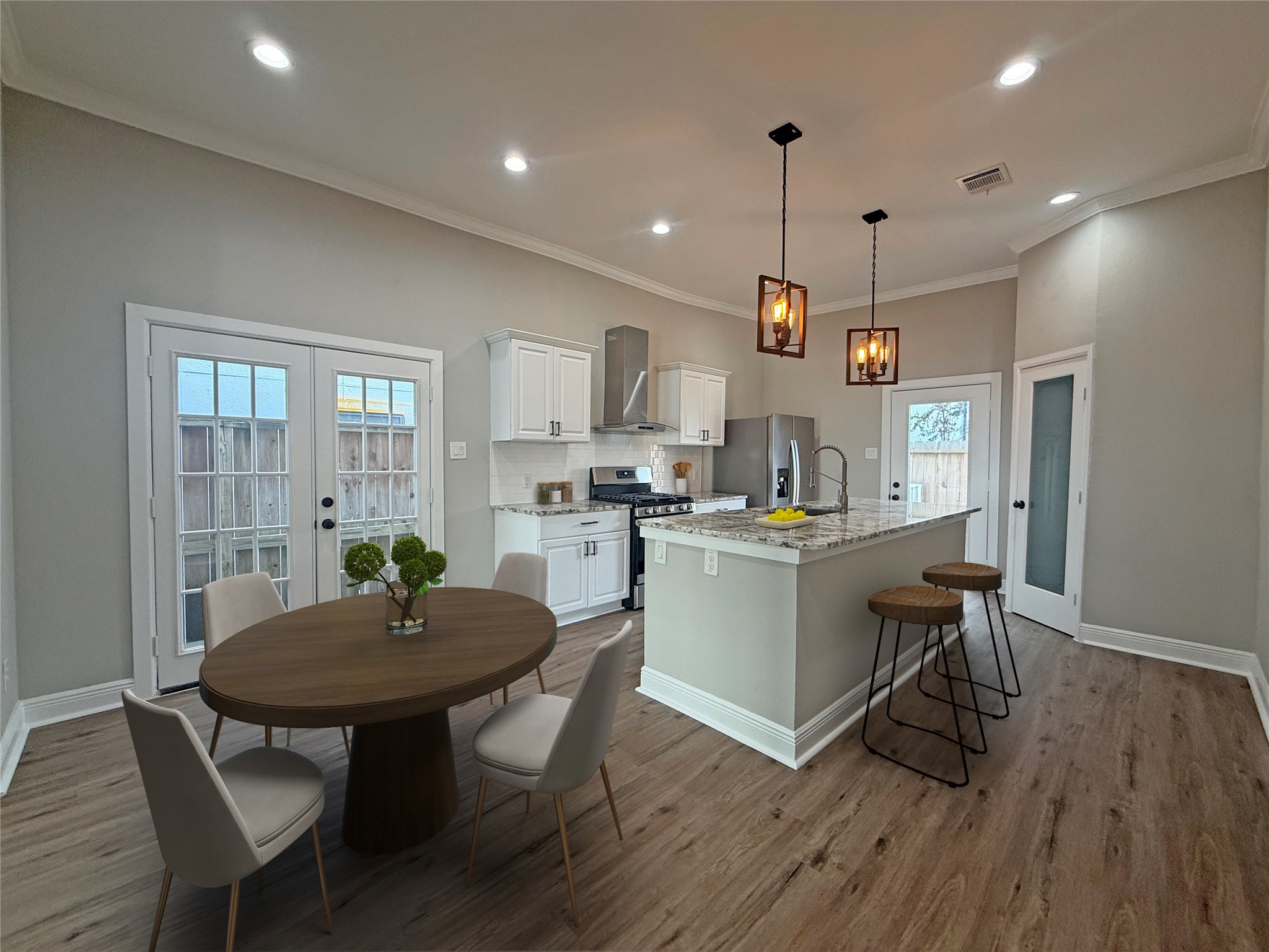 Virtually Staged: Beautifully updated kitchen and dining area, virtually staged to showcase the spacious layout, breakfast bar seating, and dining possibilities. French doors in the dining area open to a small exterior porch, adding natural light and charm.