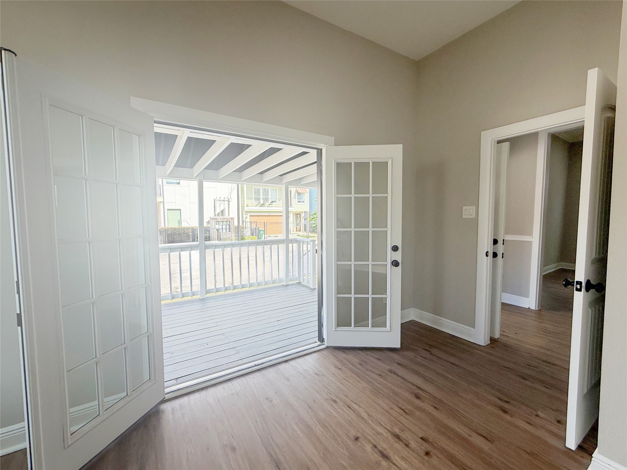 A closer perspective highlights the double French doors and their seamless connection to the covered porch, bringing a wonderful sense of openness to the room.