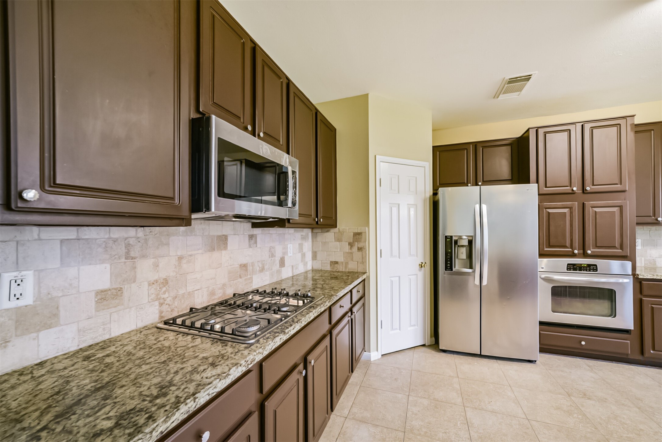 Kitchen featuring a gas cooktop and built-in appliances.