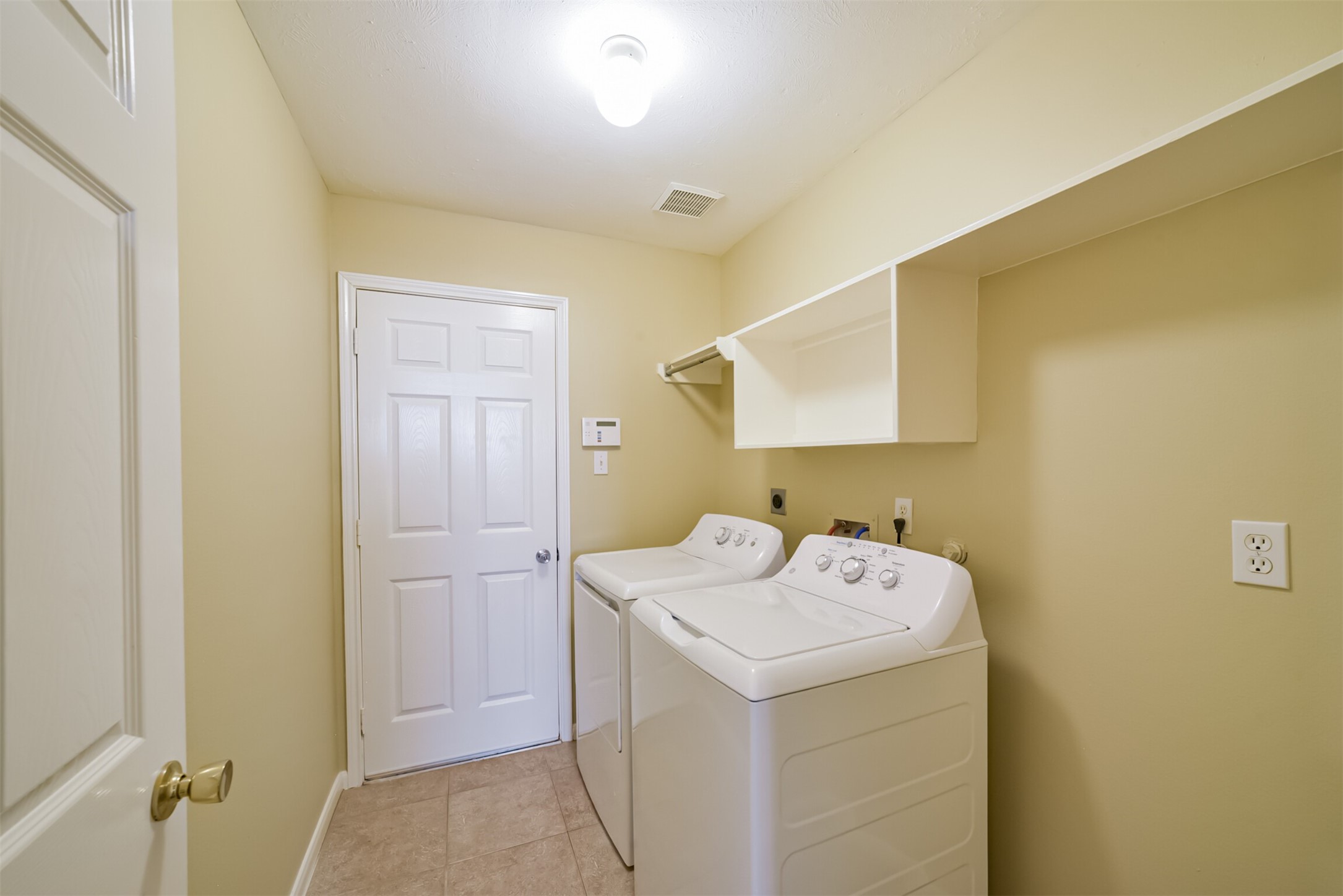 First-floor utility room with washer and dryer included.