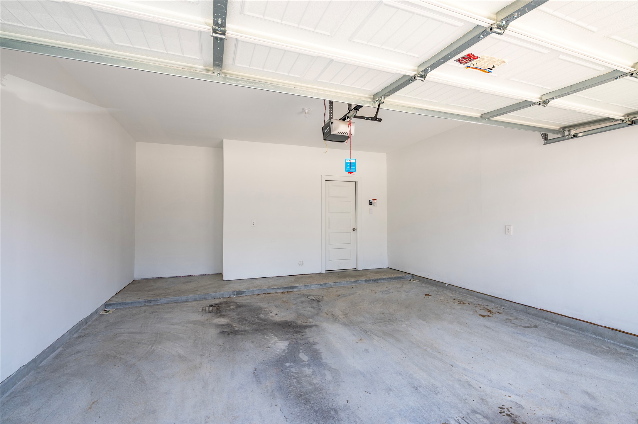 Large two car attached garage with garage door opener.