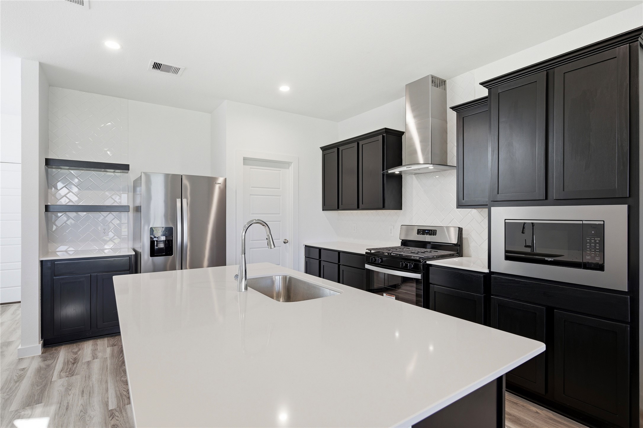 Silestone counter tops and dark wood cabinets throughout. Silestone counter tops and dark wood cabinets throughout.