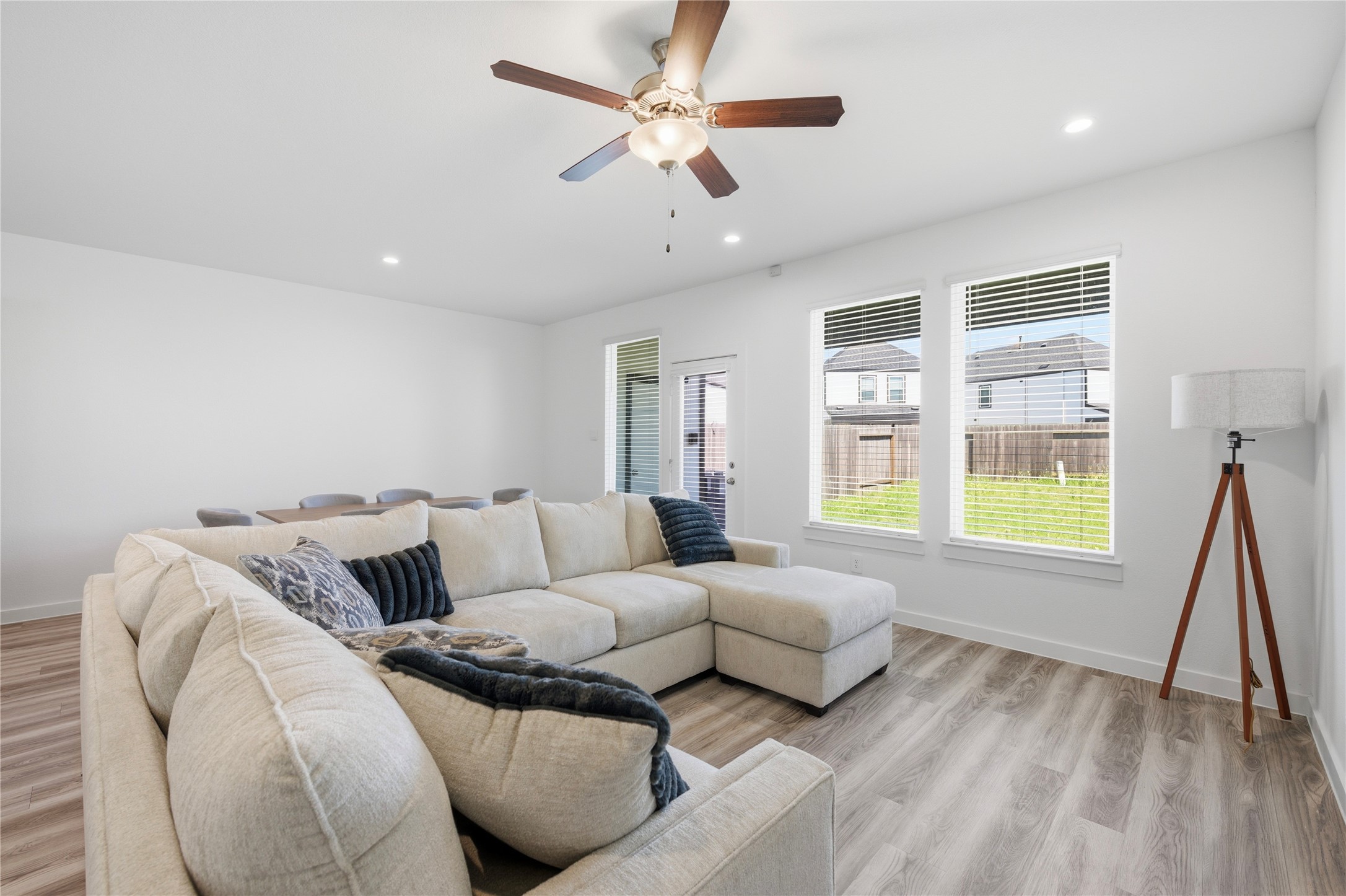 Spacious living room with backyard views.