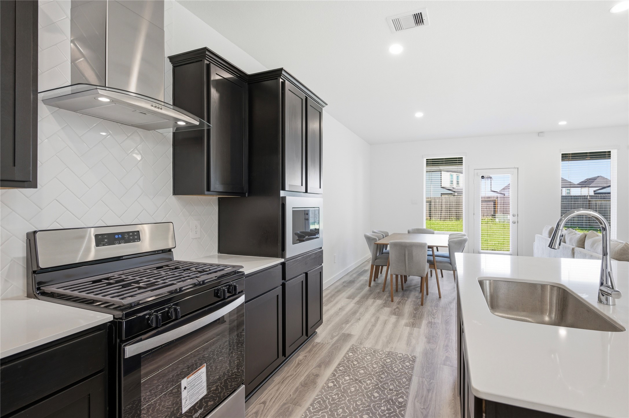 Gas range with overhead vent.