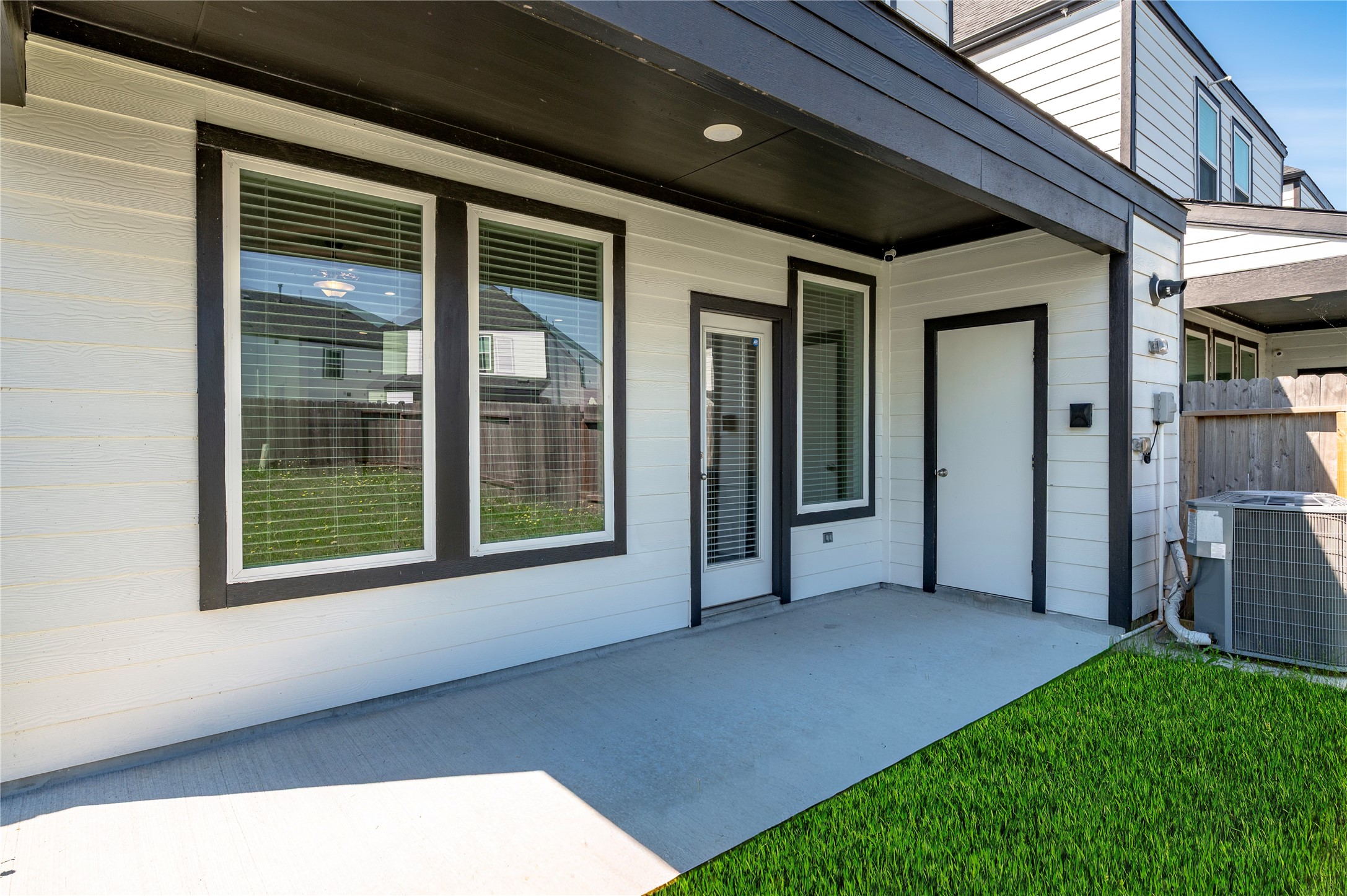 Covered concrete back patio area.
