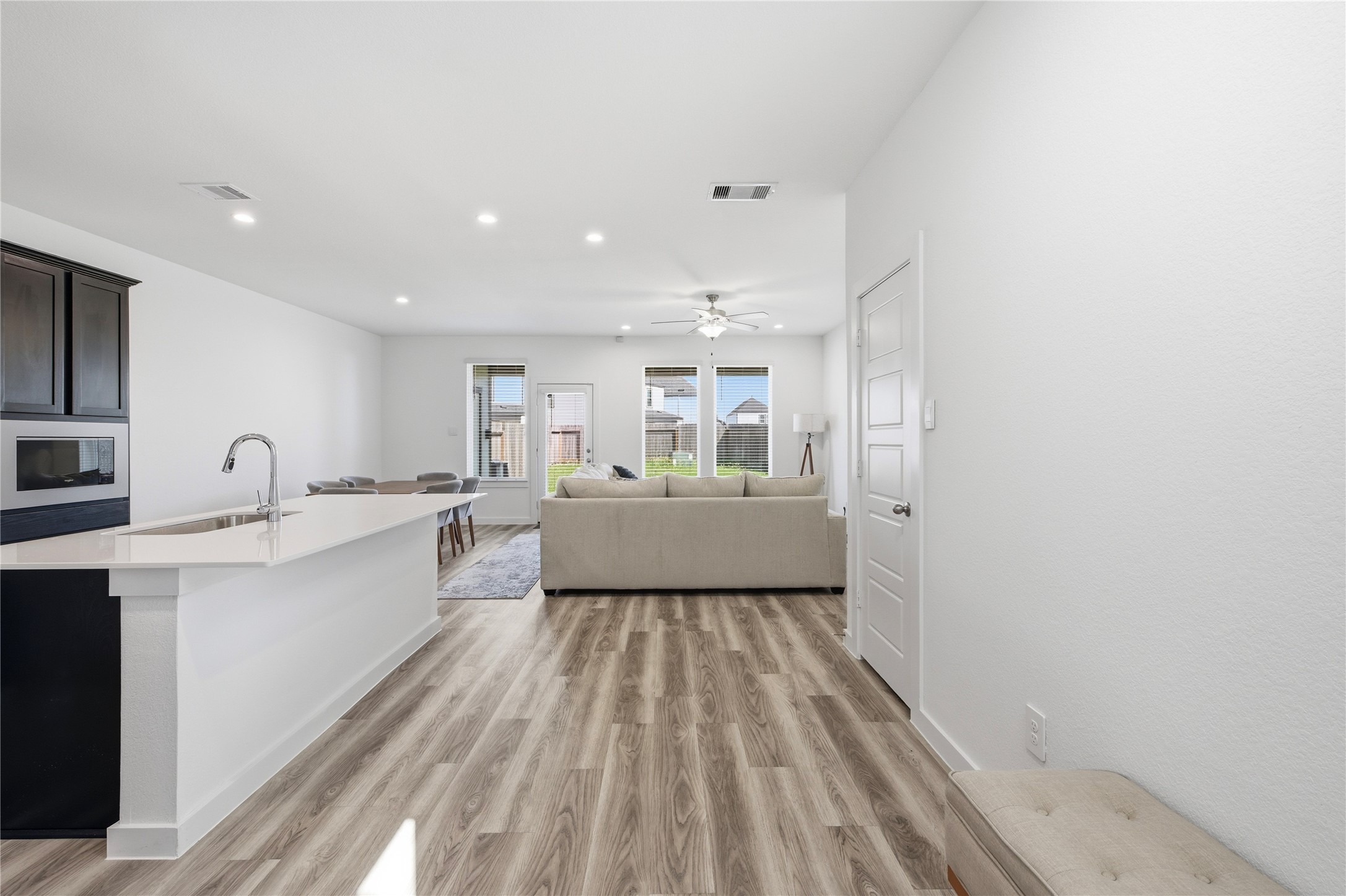 Open concept design of the first level with large kitchen, living room and dining areas. Open concept design of the first level with large kitchen, living room and dining areas.