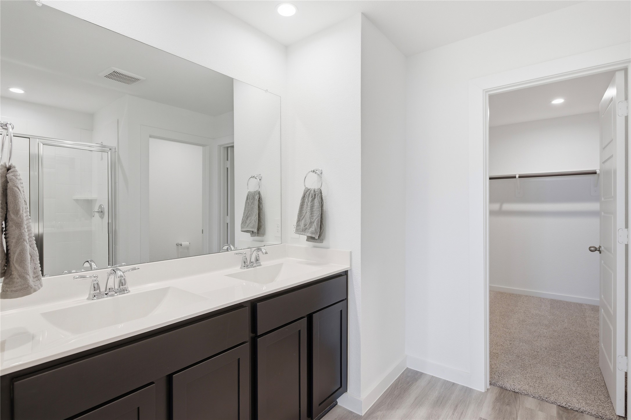 His/her sinks on the large vanity in the primary bath.