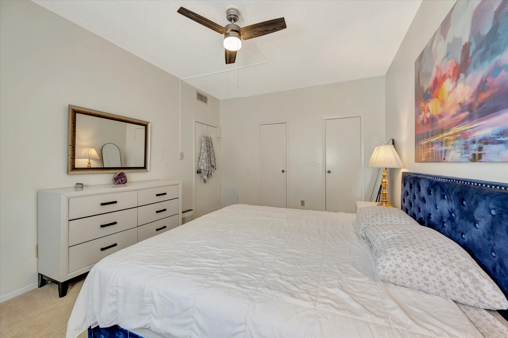Additional view of the primary bedroom showing its layout and ceiling fan.