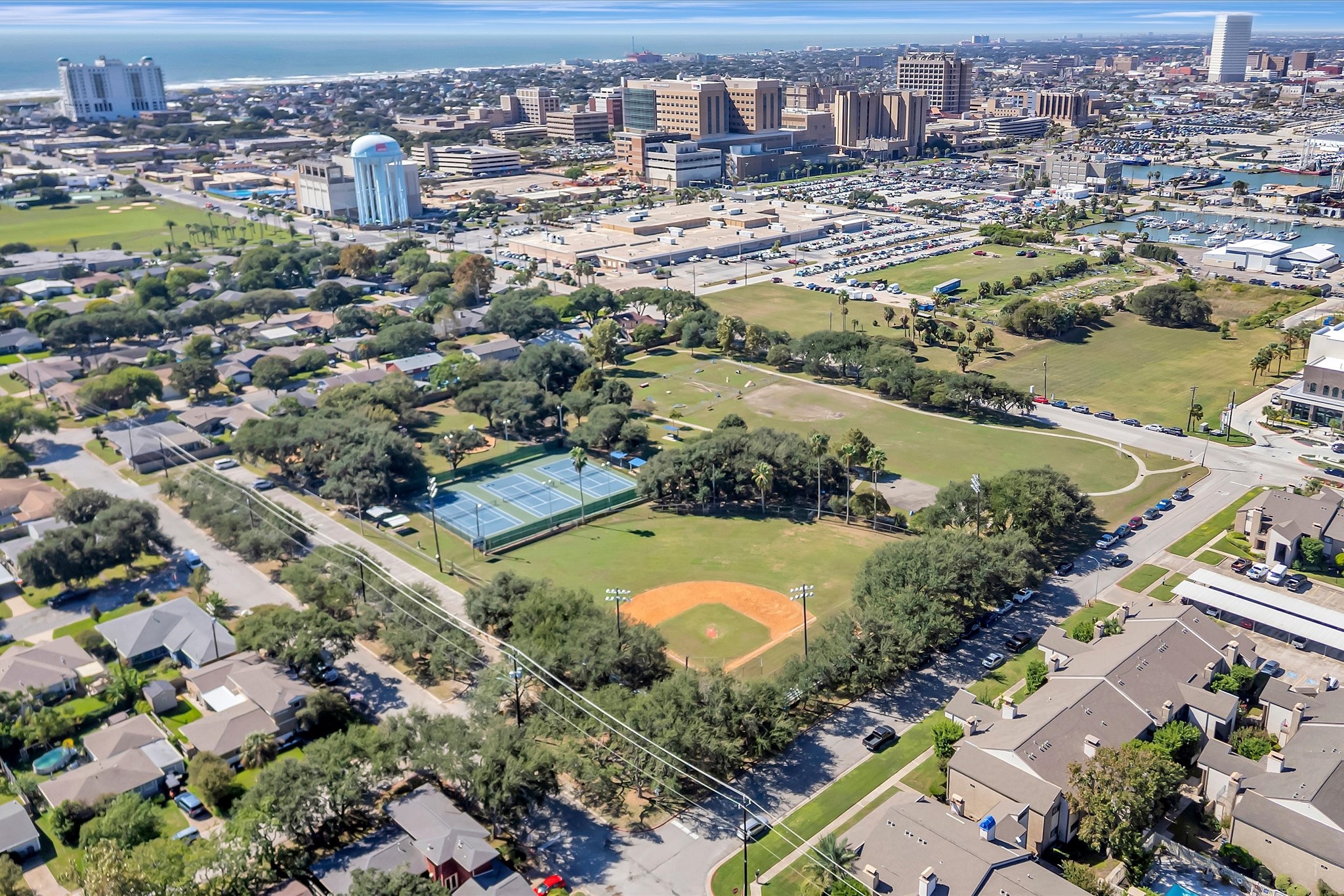 Aerial overview of the condominium community and surrounding Galveston neighborhood.