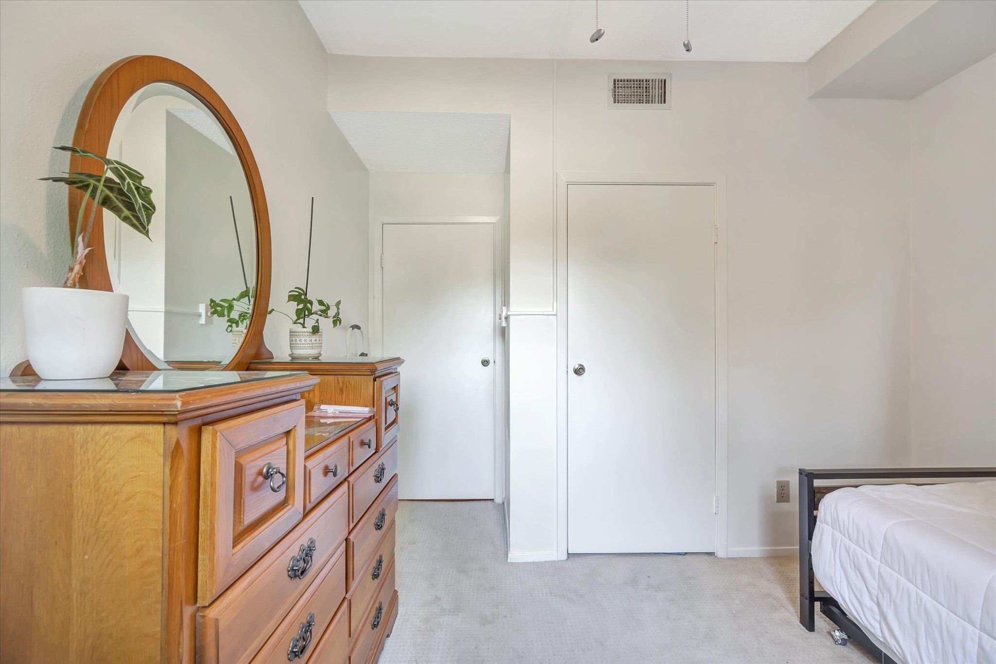 Alternate view of the secondary bedroom showing the closet and room layout.