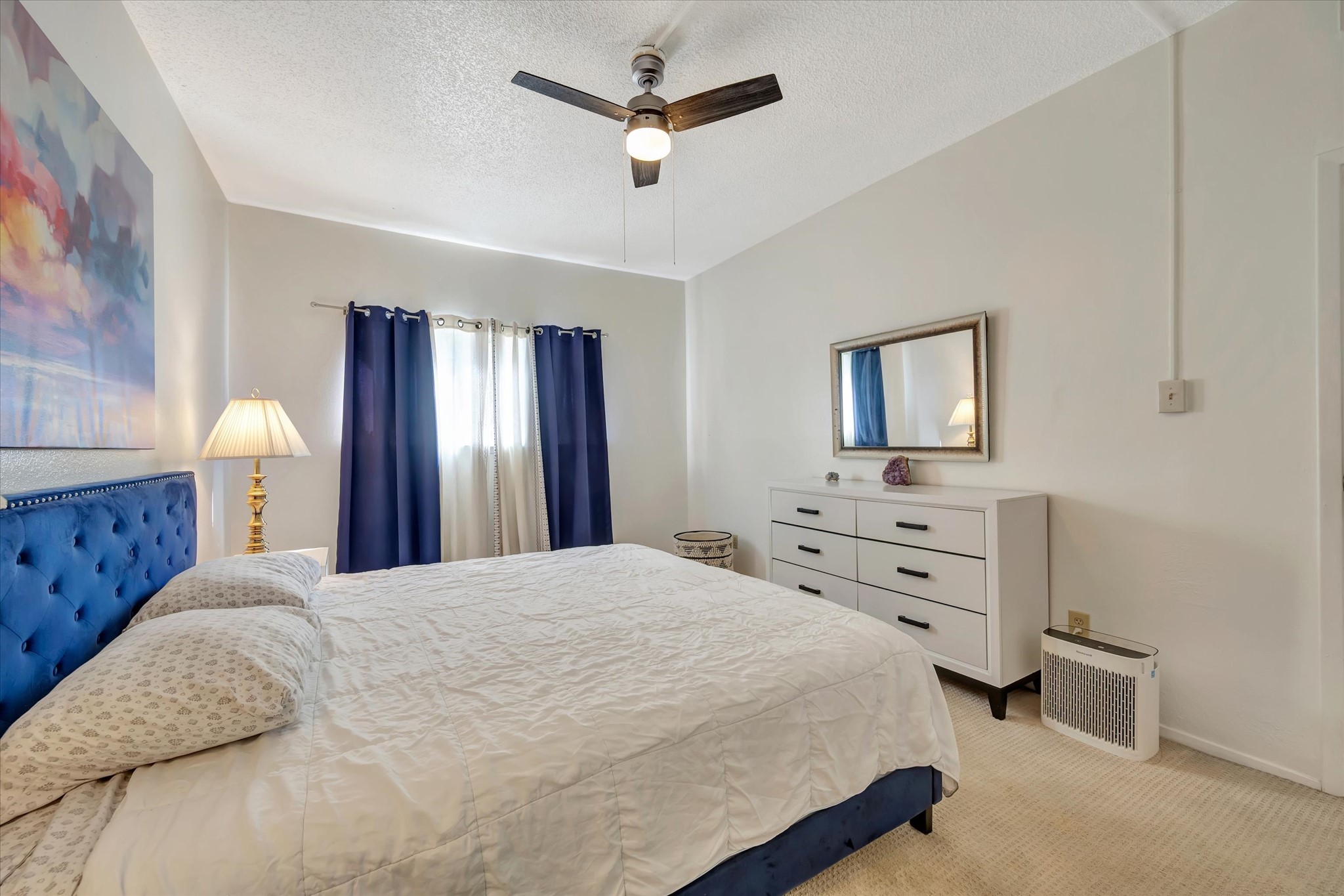 Another view of the primary bedroom showing the window and space for additional furnishings.