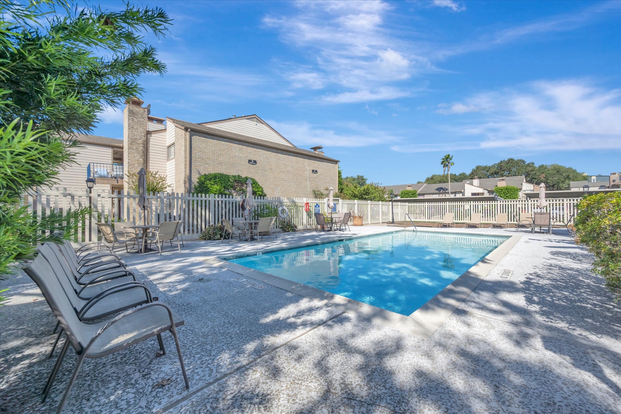 Another view of the community pool and surrounding outdoor seating area.