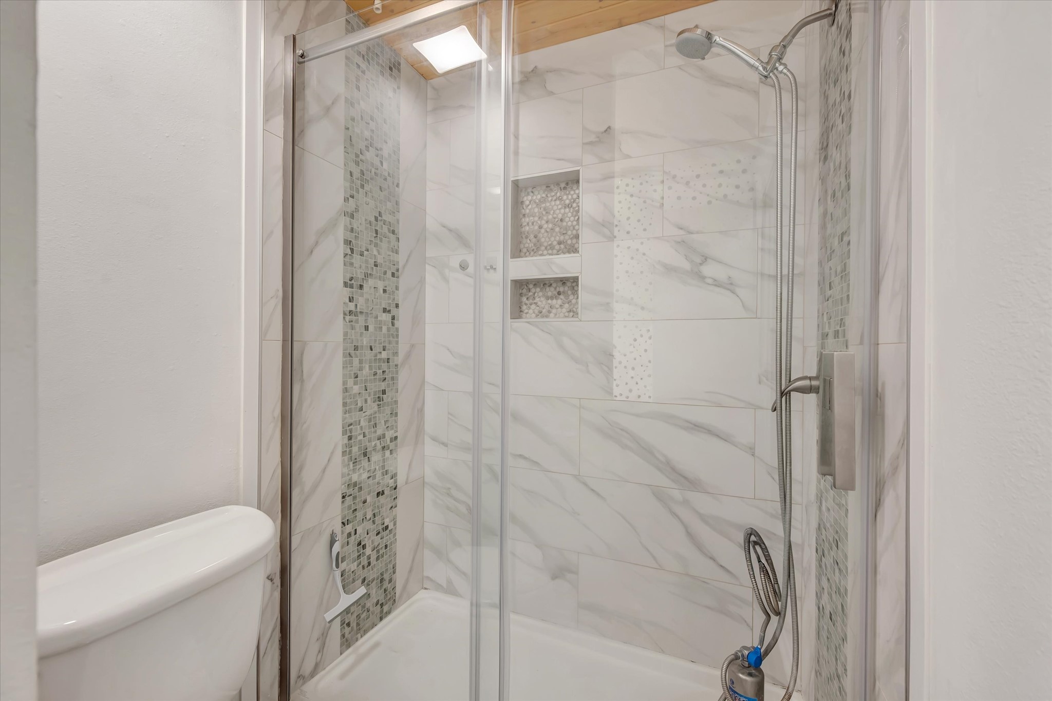 Closer look at the glass-enclosed shower, replaced during the current ownership.