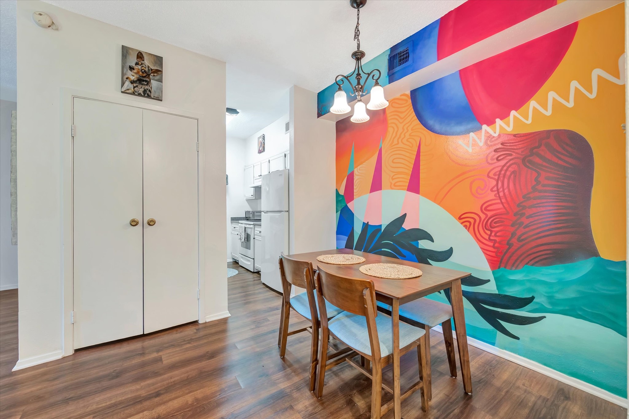 Another view of the dining space highlights the murals bold colors and full-wall design.