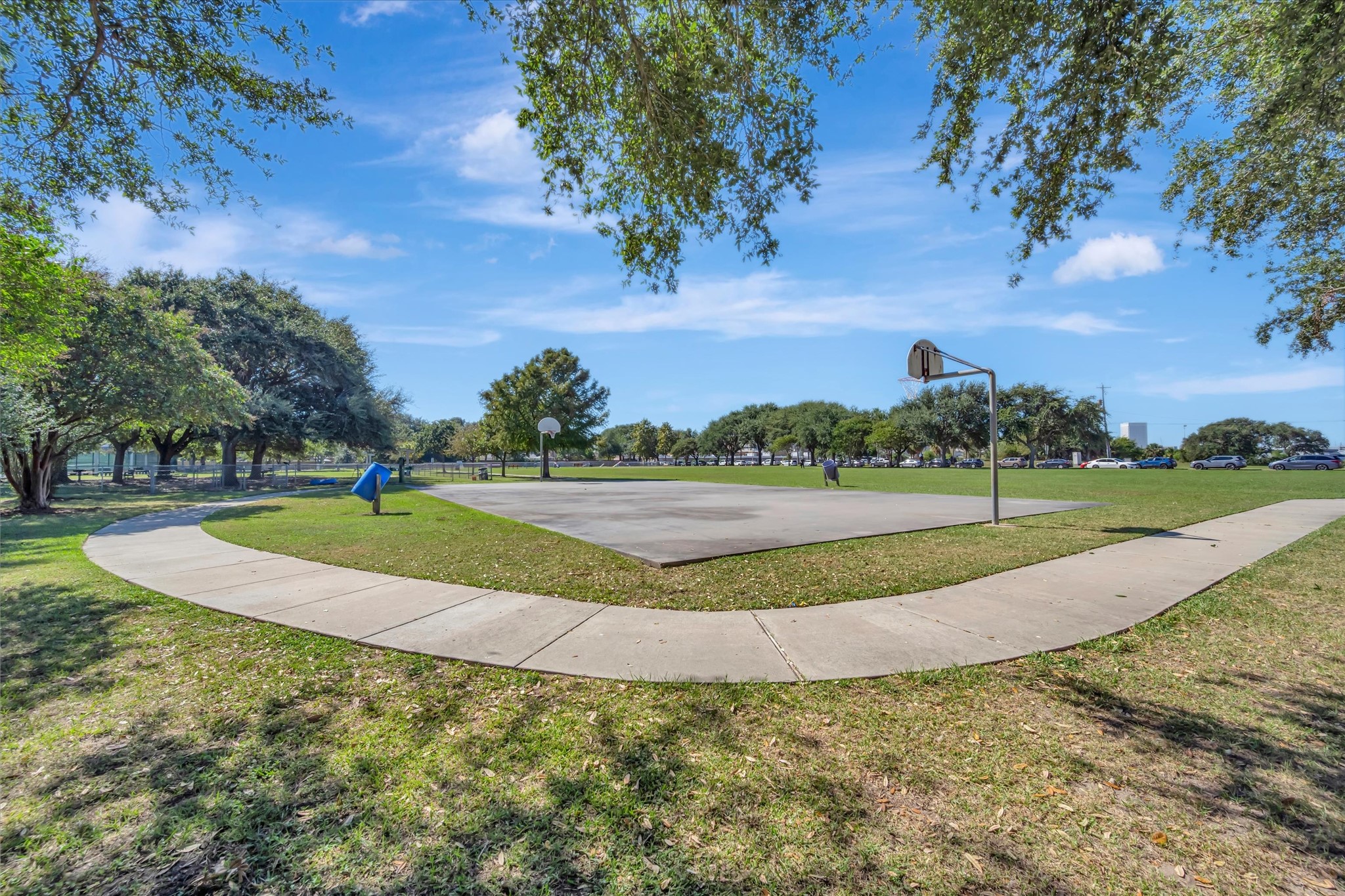Open green space and established trees within the community grounds.